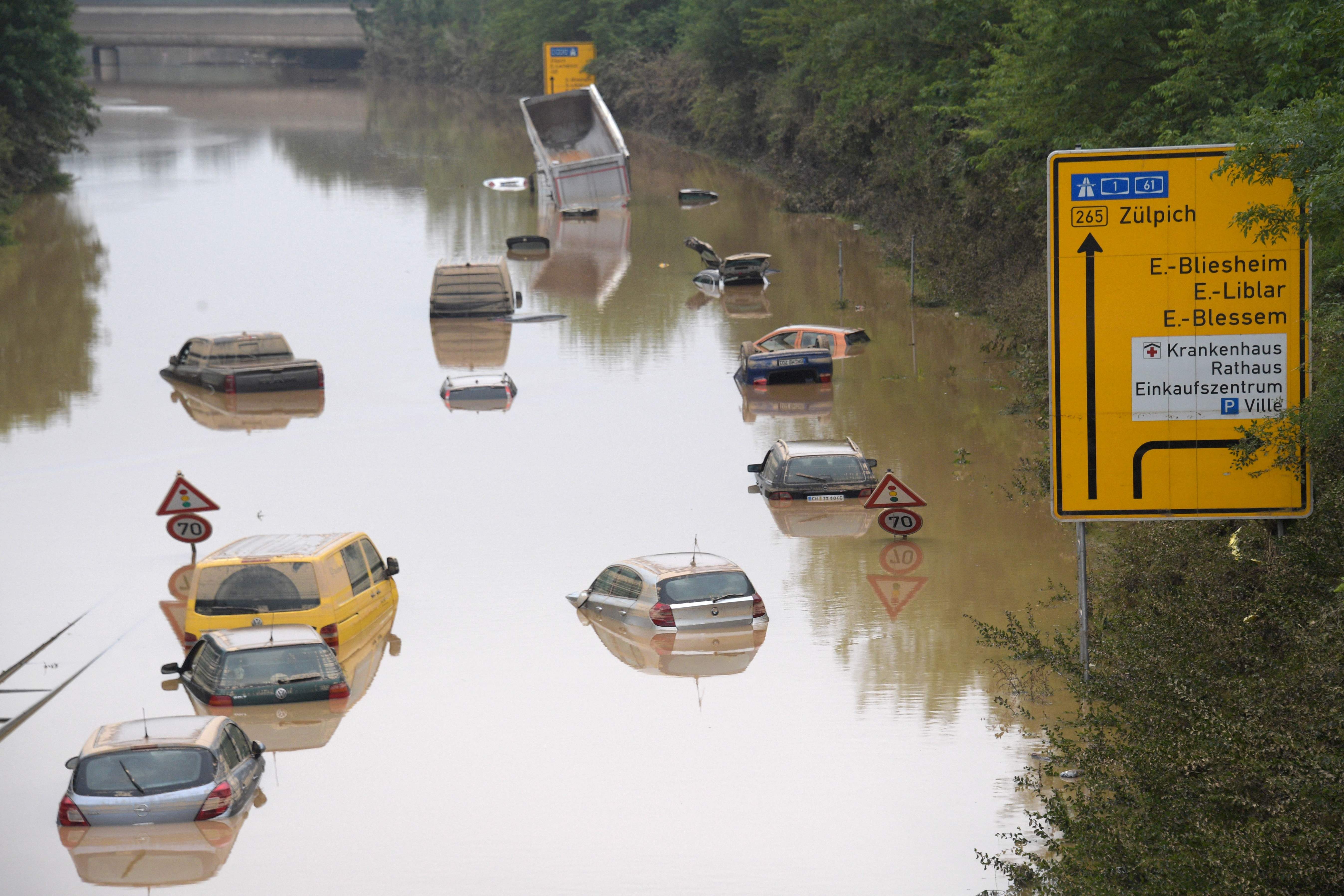 (FILES) In this file photo taken on July 17, 2021 submerged cars and other vehicles are seen on the federal highway B265 in Erftstadt, western Germany, after heavy rains hit parts of the country, causing widespread flooding and major damage. - Britain on Monday, August 9, called for urgent global action to tackle climate change, after a UN report warned the planet has warmed more than previously estimated. (Photo by SEBASTIEN BOZON / AFP)