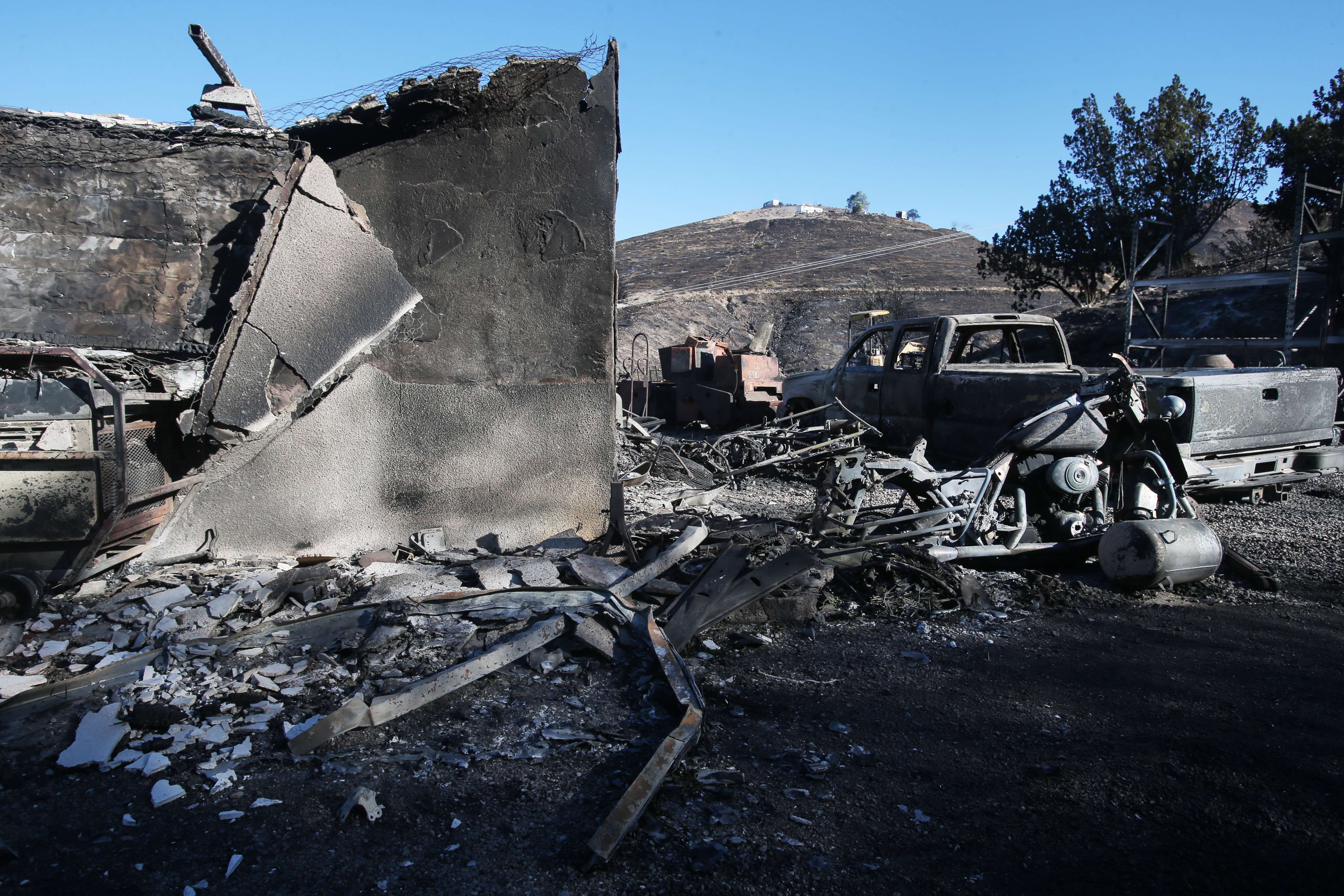 CANYON COUNTRY, CALIFORNIA - OCTOBER 25: A structure and vehicle stand scorched by the Tick Fire on October 25, 2019 in Canyon Country, California. The fire has blackened 4,300 acres thus far with around 40,000 people under mandatory evacuation orders. Mario Tama/Getty Images/AFP
== FOR NEWSPAPERS, INTERNET, TELCOS & TELEVISION USE ONLY ==