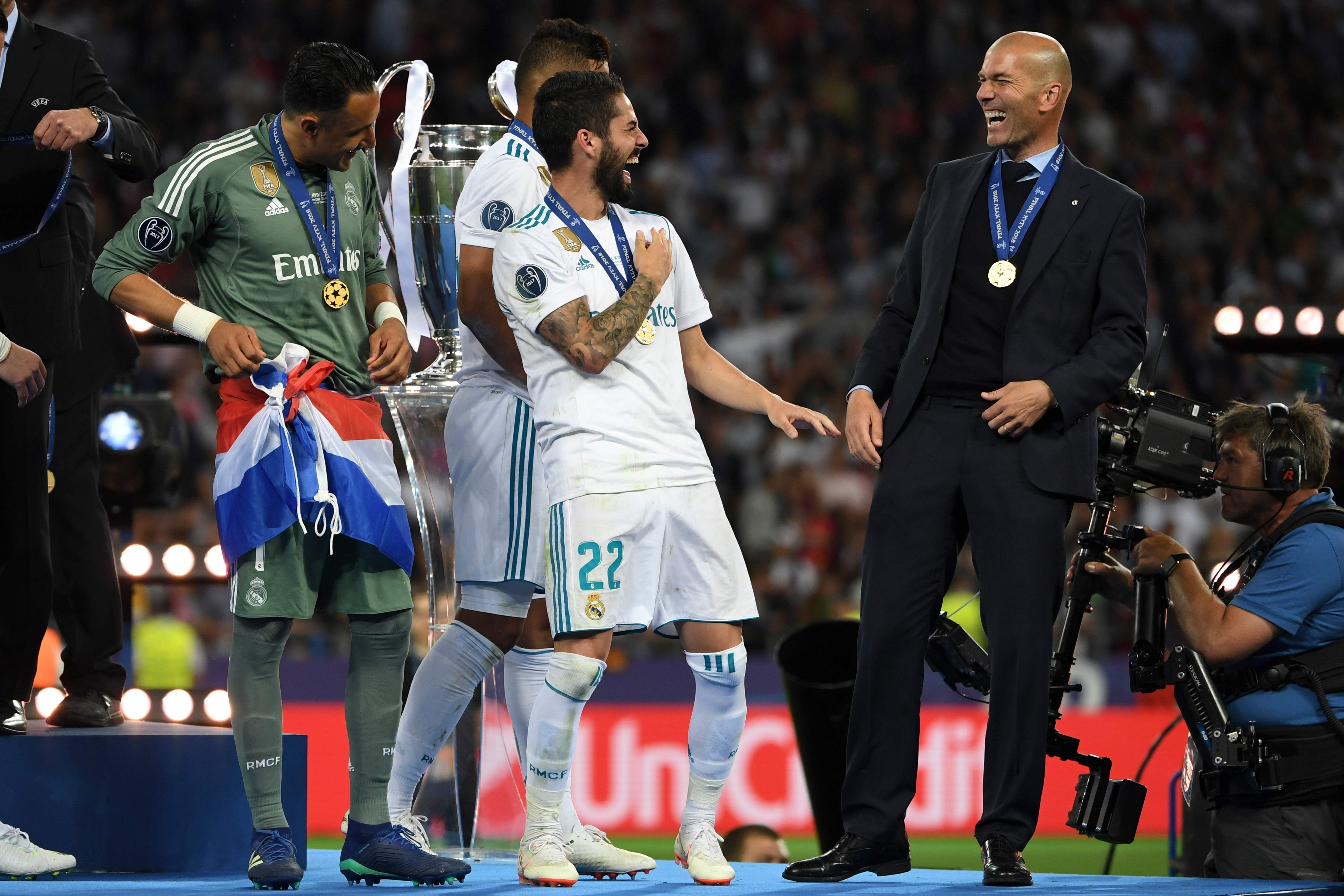El costarricense Keylor Navas, Isco y Zinedine Zidane (de izquierda a derecha) disfrutaron a lo grande tras recibir las medallas que los acreditan como campeones de la Champions League 2017-2018. Fotografía: AFP.