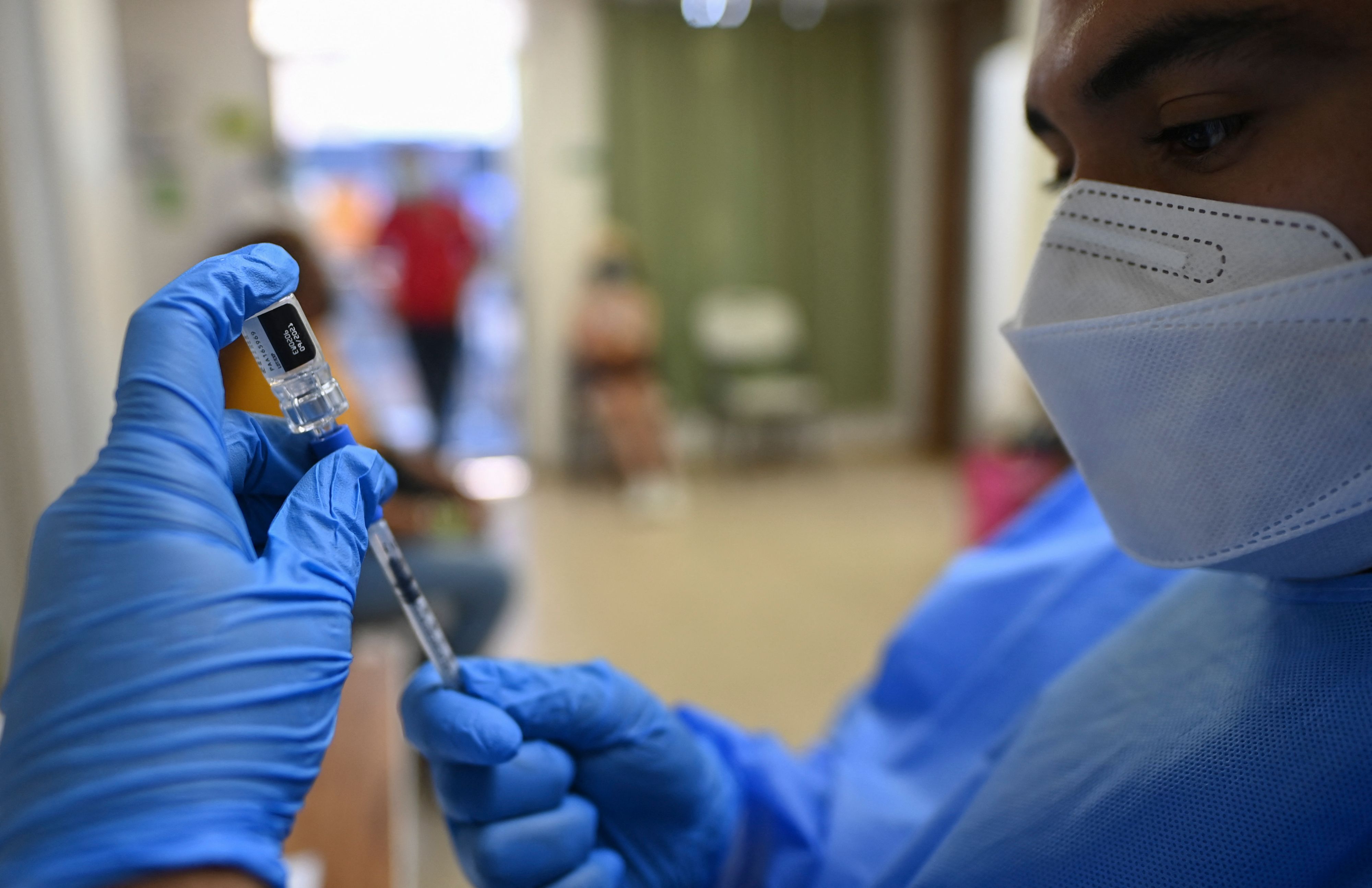 A nurse prepares a dose of the Pfizer-BioNTech vaccine against COVID-19 amid the novel coronavirus pandemic, in Taboga Island, Panama on May 21, 2021. - The Panamanian island of Taboga is free of covid-19 and its population completed the vaccination against the coronavirus, the Ministry of Health announced. All the population over 16 years of age, pregnant women, teachers, were vaccinated, and this makes a coverage of about 1,800 people on the island, which also includes the islands of Otoque East and Otoque West. (Photo by Luis ACOSTA / AFP)