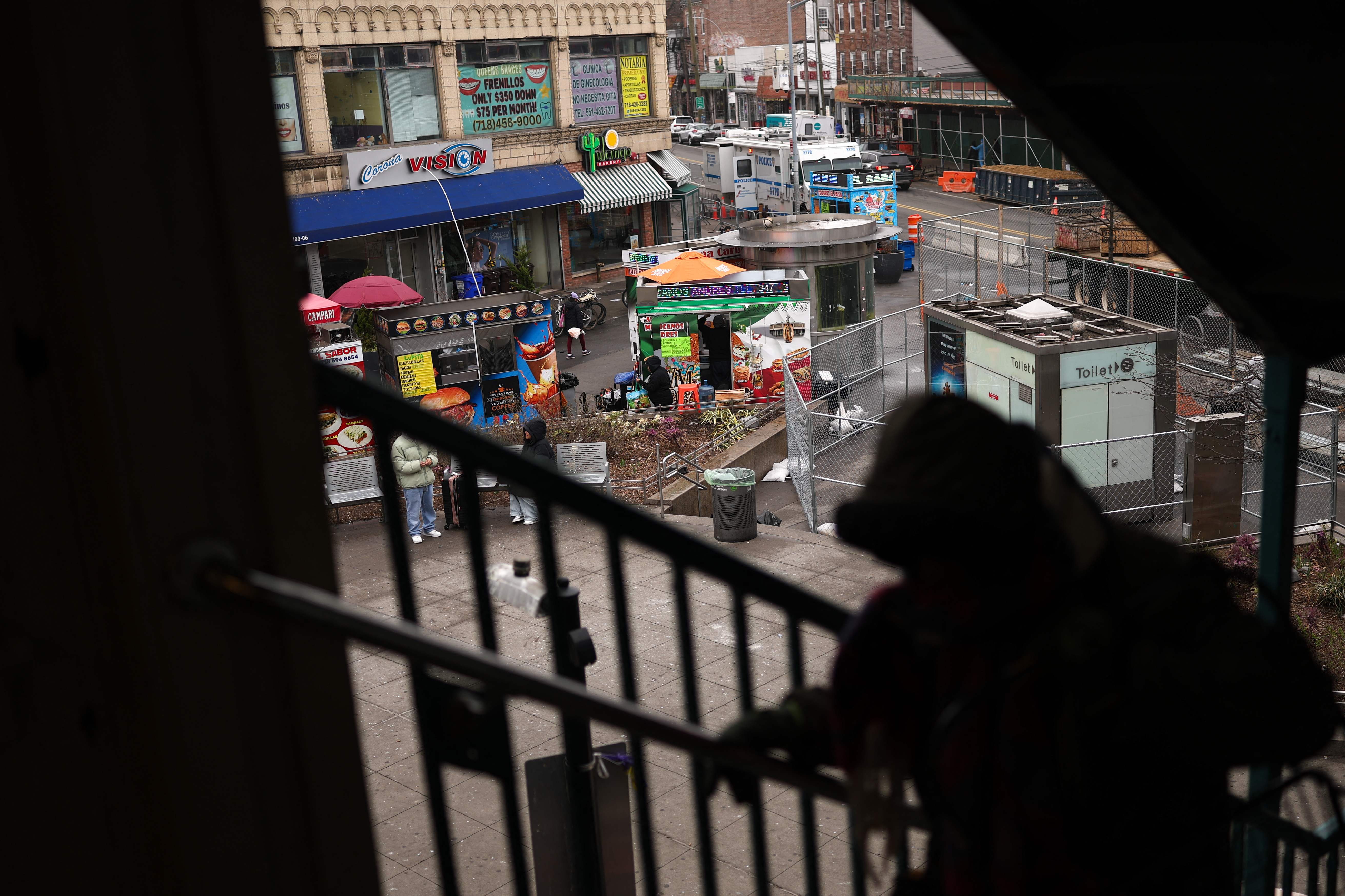 Vendors are seen below the subway station in the Corona Plaza area of the Queens borough of New York City on March 20, 2025. A local business owner says that the fear caused by President Donald Trump's immigration policies have left the streets of his largely migrant neighb