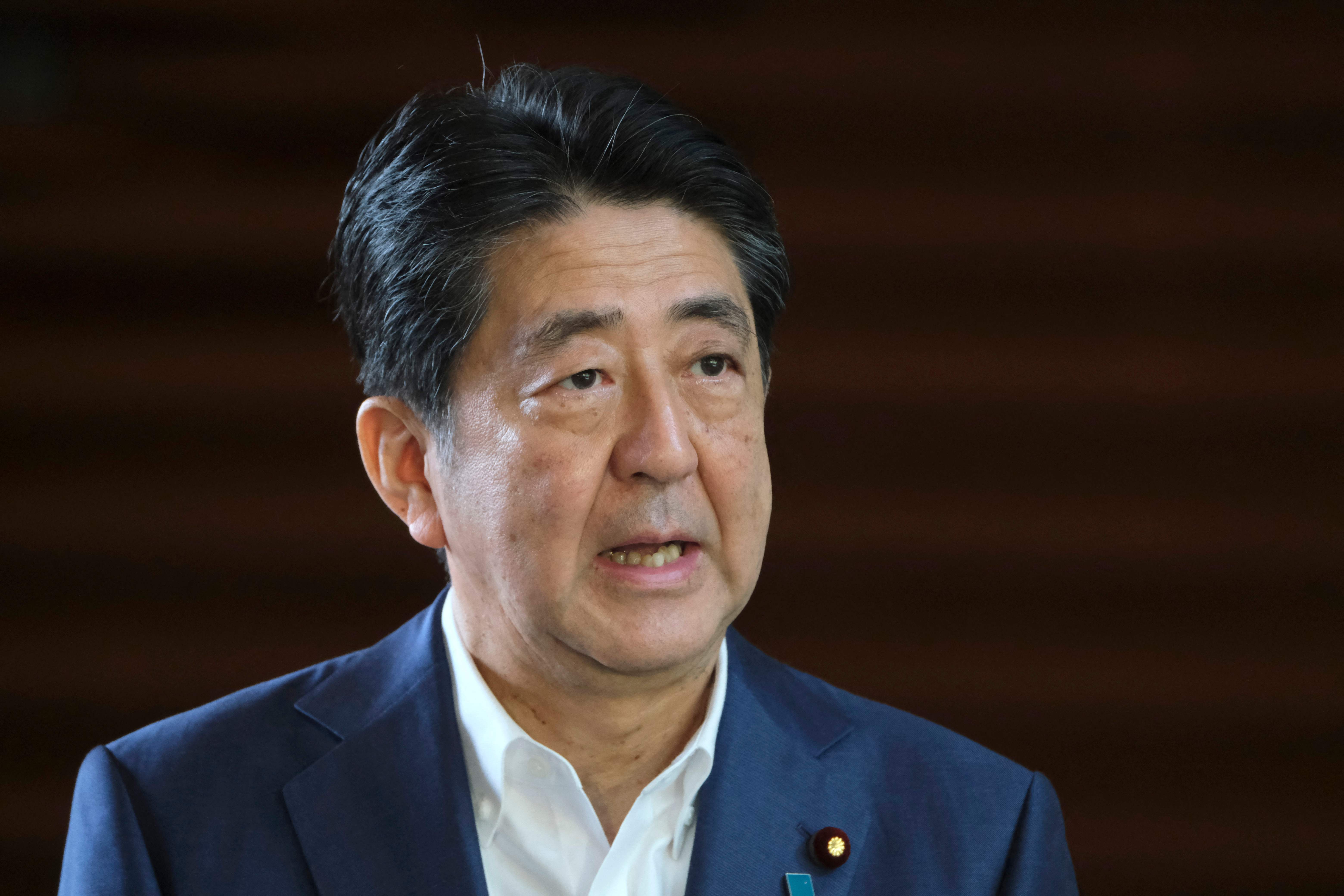 (FILES) In this file photo taken on August 24, 2020, Japan's Prime Minister Shinzo Abe speaks to the media upon his arrival at the prime minister's office. - Former Japanese prime minister Shinzo Abe was attacked and left bleeding at a campaign event in the Nara region on July 8, 2022, local media reported. (Photo by Kazuhiro NOGI / AFP)