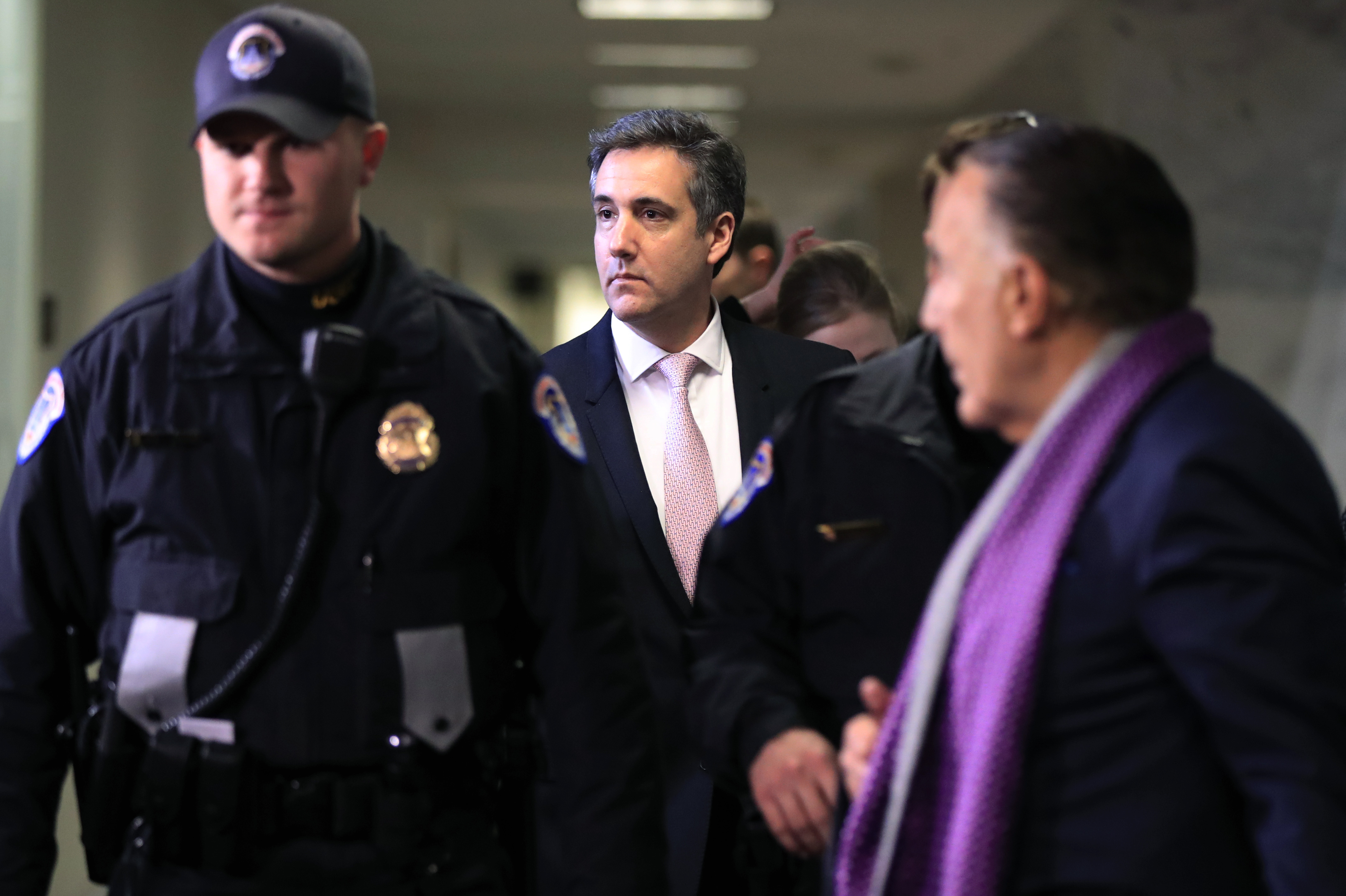 Michael Cohen, President Donald Trump's former lawyer, center, leaves after a closed door Senate Intelligence Committee hearing on Capitol Hill in Washington, Tuesday, Feb. 26, 2019. (AP Photo/Manuel Balce Ceneta)