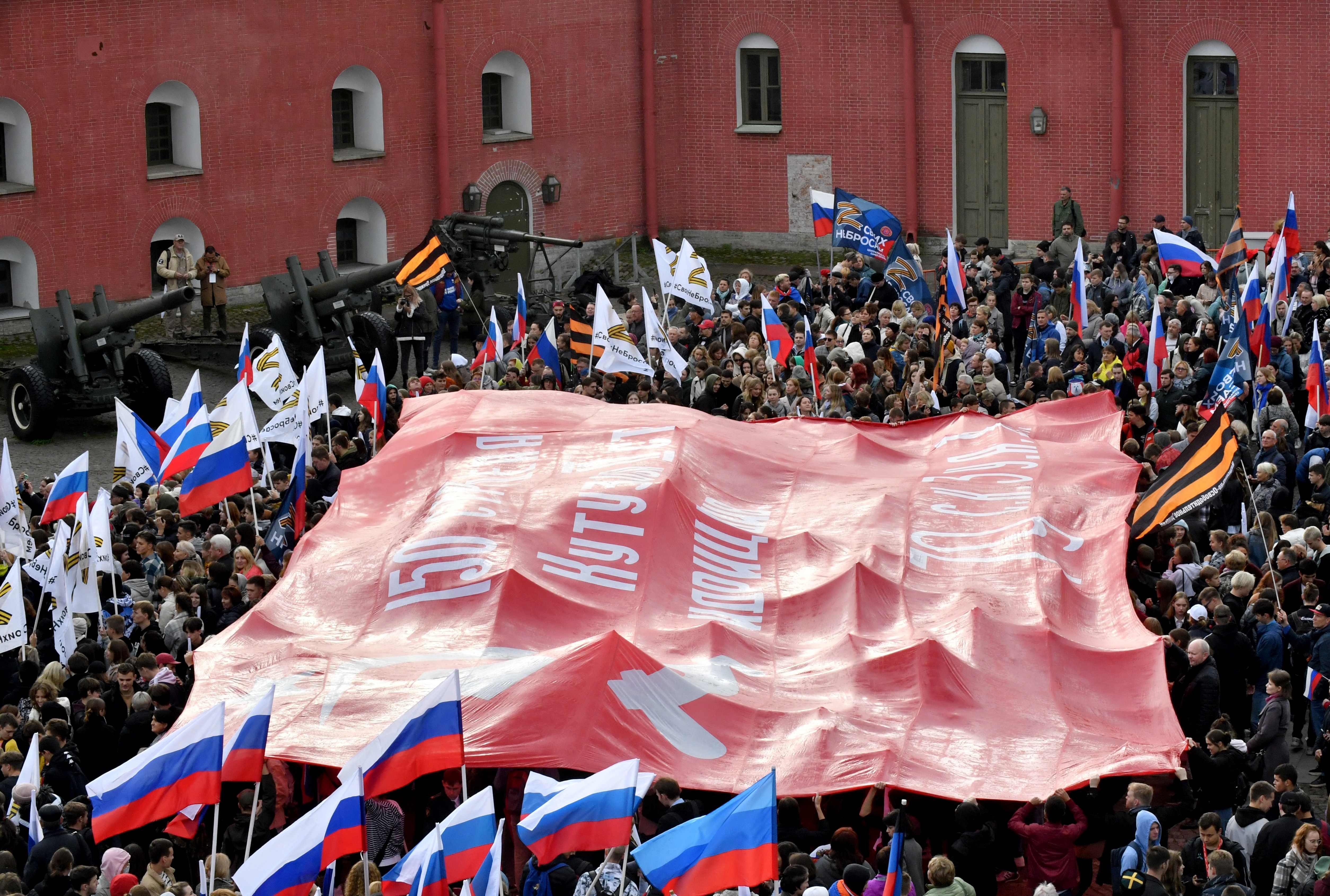 People attend a rally and a concert in support of annexation referendums in Russian-held regions of Ukraine, in Saint Petersburg on September 23, 2022. - Voting on whether Russia should annex Kremlin-controlled regions of Ukraine opened Friday as the West denounced the referendum that has dramatically raised the stakes of Moscow's seven-month invasion. (Photo by Olga MALTSEVA / AFP)