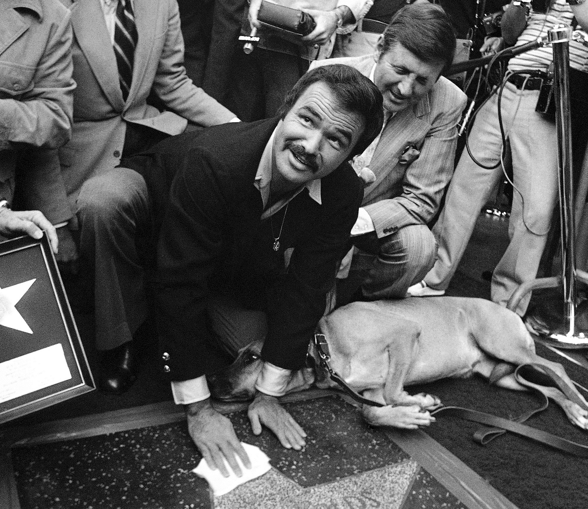 FILE - In this March 15, 1978 file photo, actor Burt Reynolds polishes star that was unveiled in the Hollywood Walk of Fame in Los Angeles. Reynolds, who starred in films including "Deliverance," "Boogie Nights," and the "Smokey and the Bandit" films, died at age 82, according to his agent. (AP Photo/file)