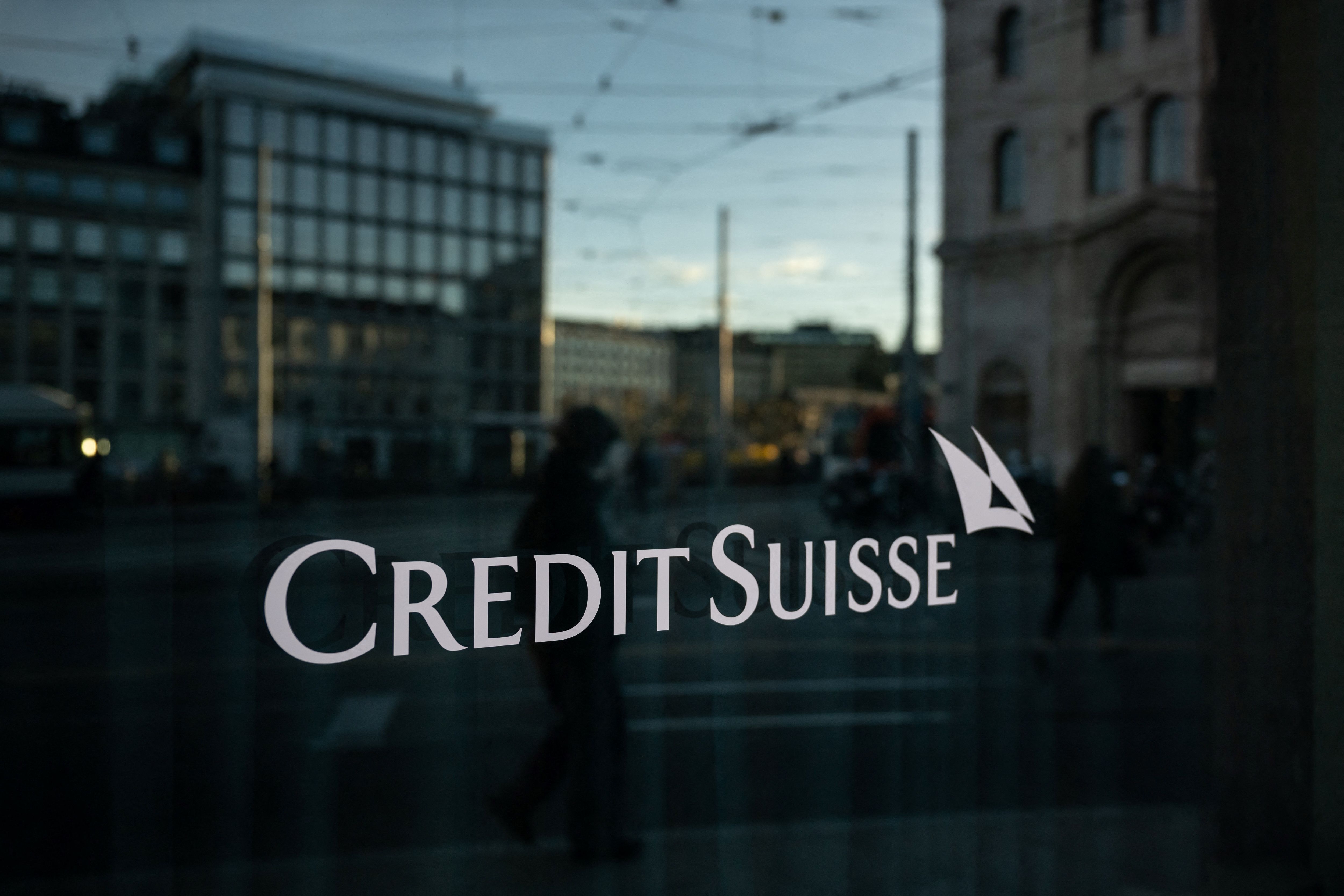 A sign of Credit Suisse bank is seen on a branch in Geneva, on March 15, 2023. - Asian markets slid on March 16, 2023 led again by banks, with contagion talk sweeping across trading floors owing to fears about European giant Credit Suisse. (Photo by Fabrice COFFRINI / AFP)