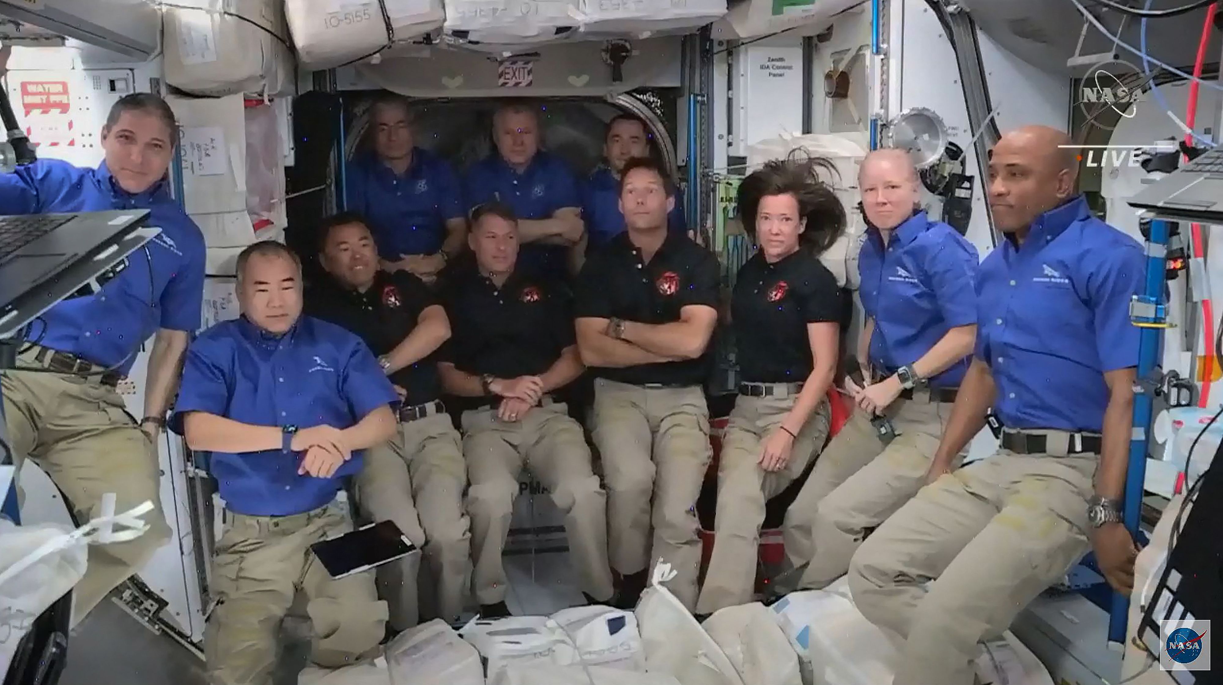 TOPSHOT - This screen grab taken from the NASA live feed shows crew members of the International Space Station welcoming crew members of the SpaceX's Crew Dragon spacecraft, on April 24. - A recycled SpaceX Crew Dragon capsule with four astronauts aboard, ESA (European Space Agency) astronaut Thomas Pesquet, NASA astronauts Megan McArthur and Shane Kimbrough, and Japan Aerospace Exploration Agency (JAXA) astronaut Akihiko Hoshide, was speeding on its way to the International Space Station, where the spacecraft is set to dock early Saturday. (Photo by - / NASA / AFP) / RESTRICTED TO EDITORIAL USE - MANDATORY CREDIT "AFP PHOTO / NASA " - NO MARKETING - NO ADVERTISING CAMPAIGNS - DISTRIBUTED AS A SERVICE TO CLIENTS