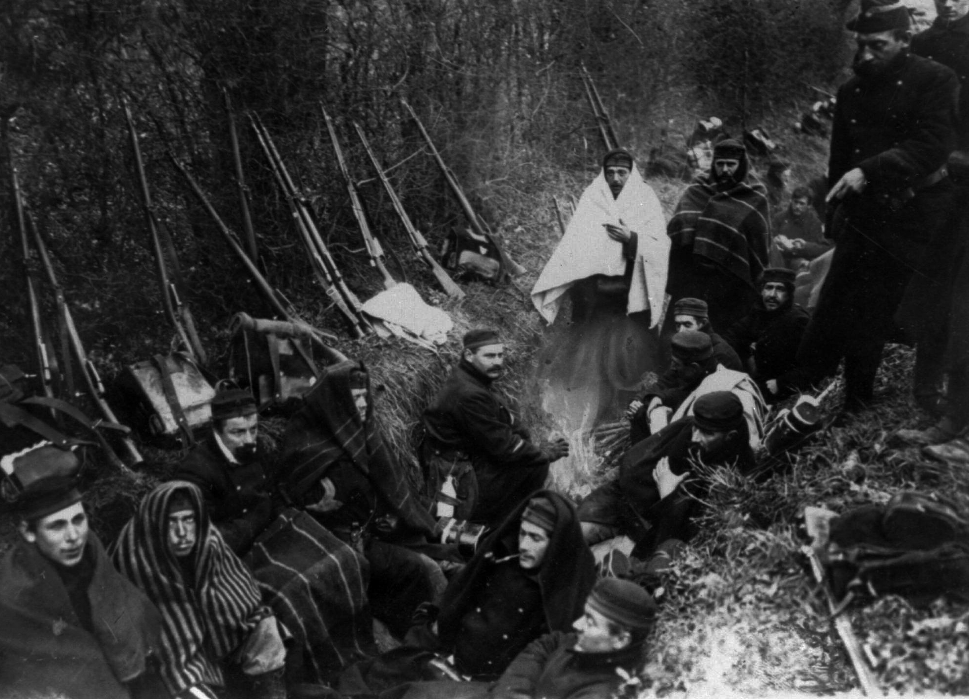 TWENTY ONE OF ONE HUNDRED PHOTOS WORLD WAR ONE CENTENARY TIMELINE - In this 1914 file photo, Allied troops huddle in a trench around a tiny fire near Ypres, Belgium. (AP Photo, File)