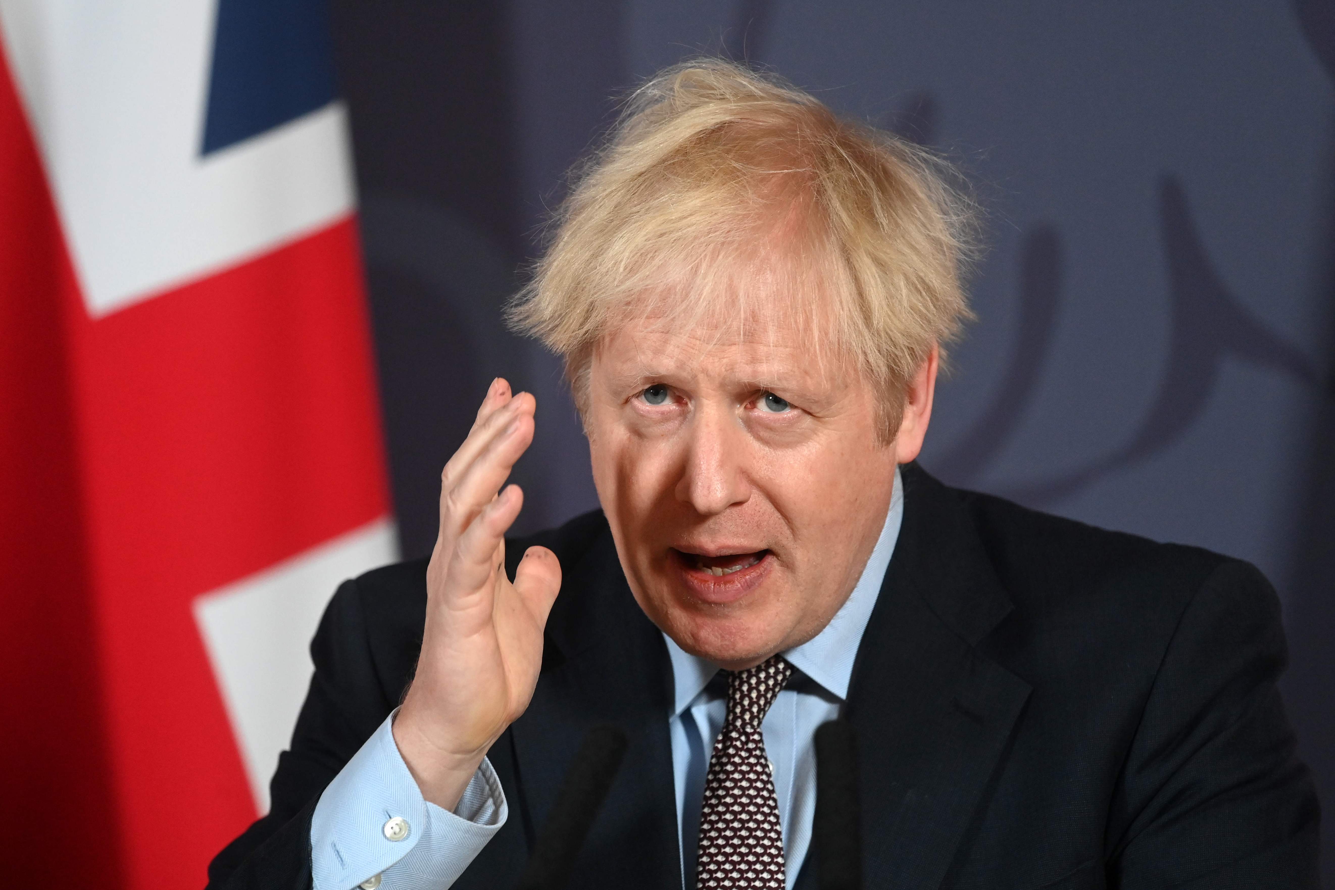 Britain's Prime Minister Boris Johnson gestures as he holds a remote press conference to update the nation on the post-Brexit trade agreement, inside 10 Downing Street in central London on December 24, 2020. - Britain said on Thursday, December 24, 2020 an agreement had been secured on the country's future relationship with the European Union, after last-gasp talks just days before a cliff-edge deadline. (Photo by Paul GROVER / POOL / AFP)