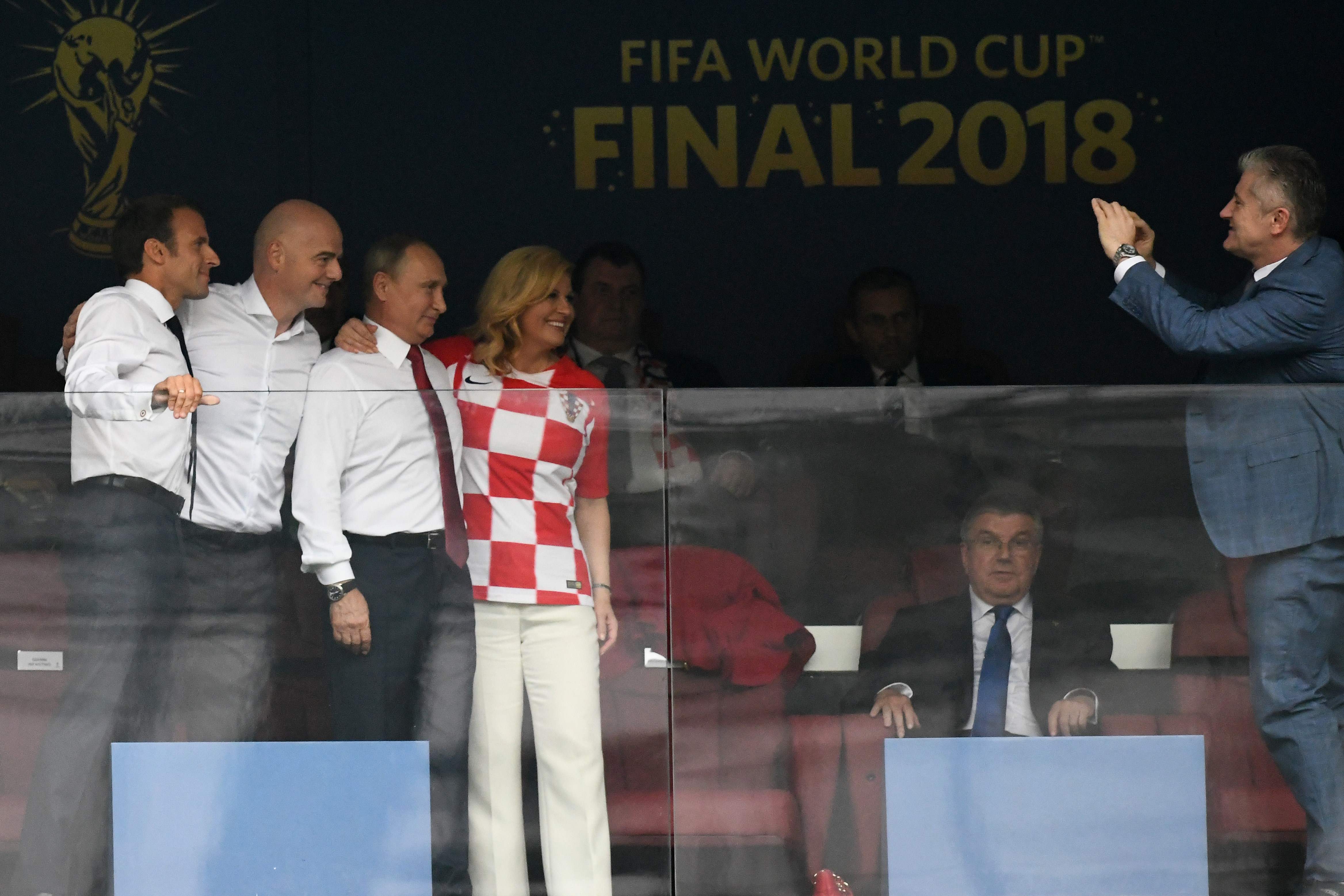 (LtoR) French President Emmanuel Macron, FIFA president Gianni Infantino, Russian President Vladimir Putin and Croatian President Kolinda Grabar-Kitarovic pose for a picture taken by Croatia's former player Davor Suker (R) ahead of the Russia 2018 World Cup final football match between France and Croatia at the Luzhniki Stadium in Moscow on July 15, 2018. / AFP PHOTO / Christophe SIMON / RESTRICTED TO EDITORIAL USE - NO MOBILE PUSH ALERTS/DOWNLOADS
