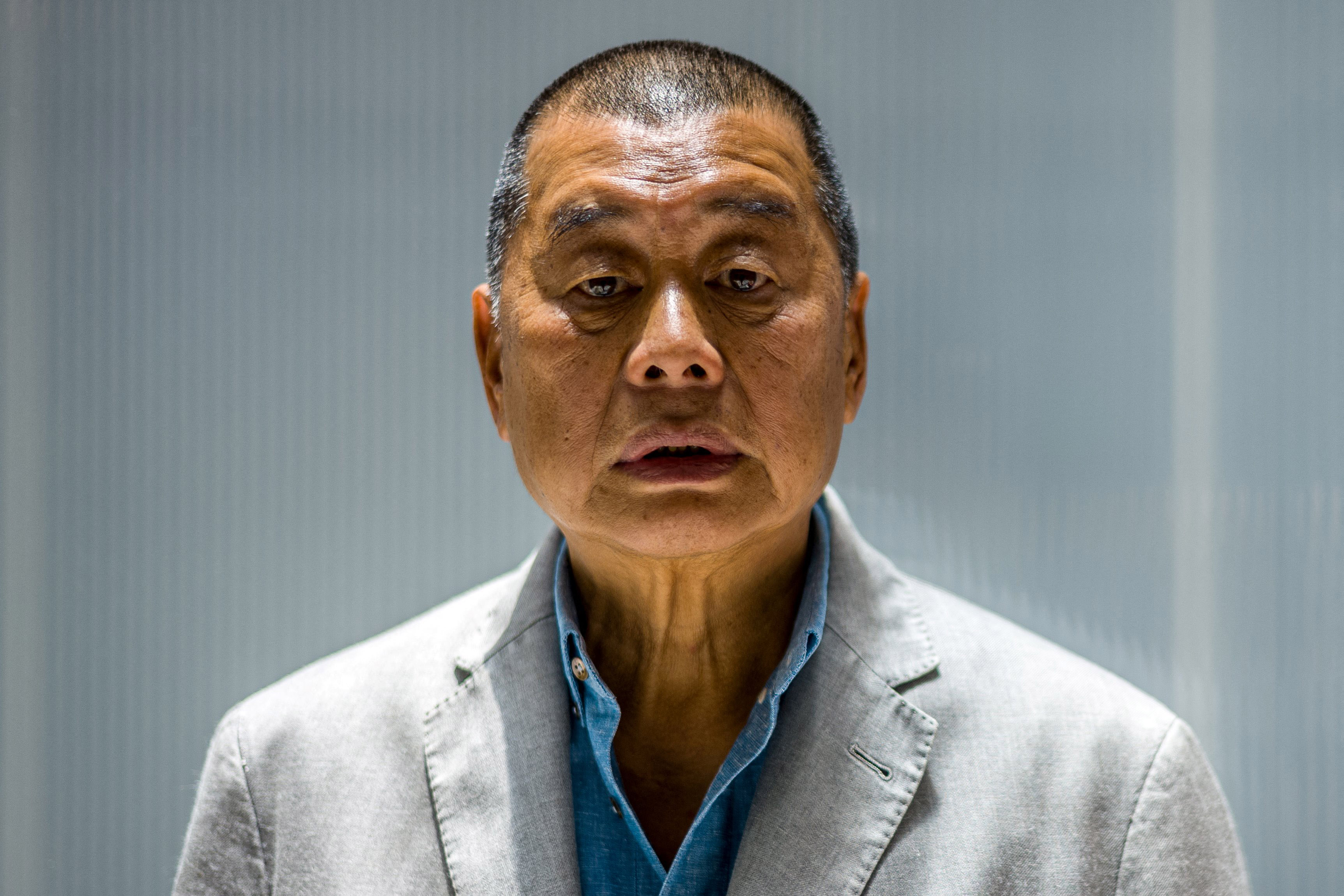 (FILES) In this file photo taken on June 16, 2020, millionaire media tycoon Jimmy Lai, 72, poses during an interview with AFP at the Next Digital offices in Hong Kong. - Lai was jailed for 12 months on April 16, 2021 over one of the city's biggest ever protests in 2019. (Photo by Anthony WALLACE / AFP)