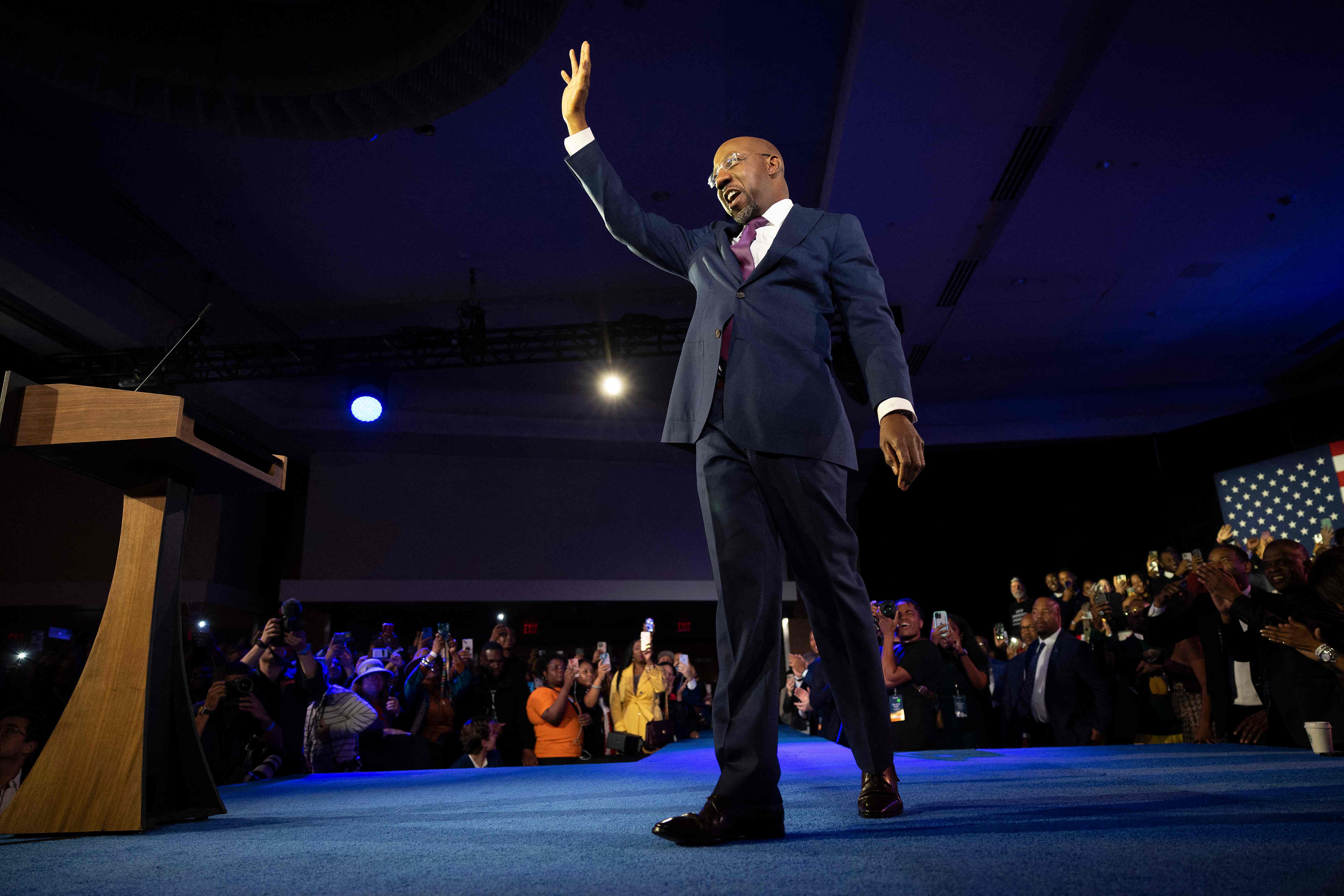 ATLANTA, GEORGIA - DECEMBER 06: Georgia Democratic Senate candidate U.S. Sen. Raphael Warnock (D-GA) waves to supporters as he walks on stage to speak during an election night watch party at the Marriott Marquis on December 6, 2022 in Atlanta, Georgia. Sen. Warnock has tonight defeated his Republican challenger Herschel Walker in a runoff election. Win McNamee/Getty Images/AFP (Photo by WIN MCNAMEE / GETTY IMAGES NORTH AMERICA / Getty Images via AFP)