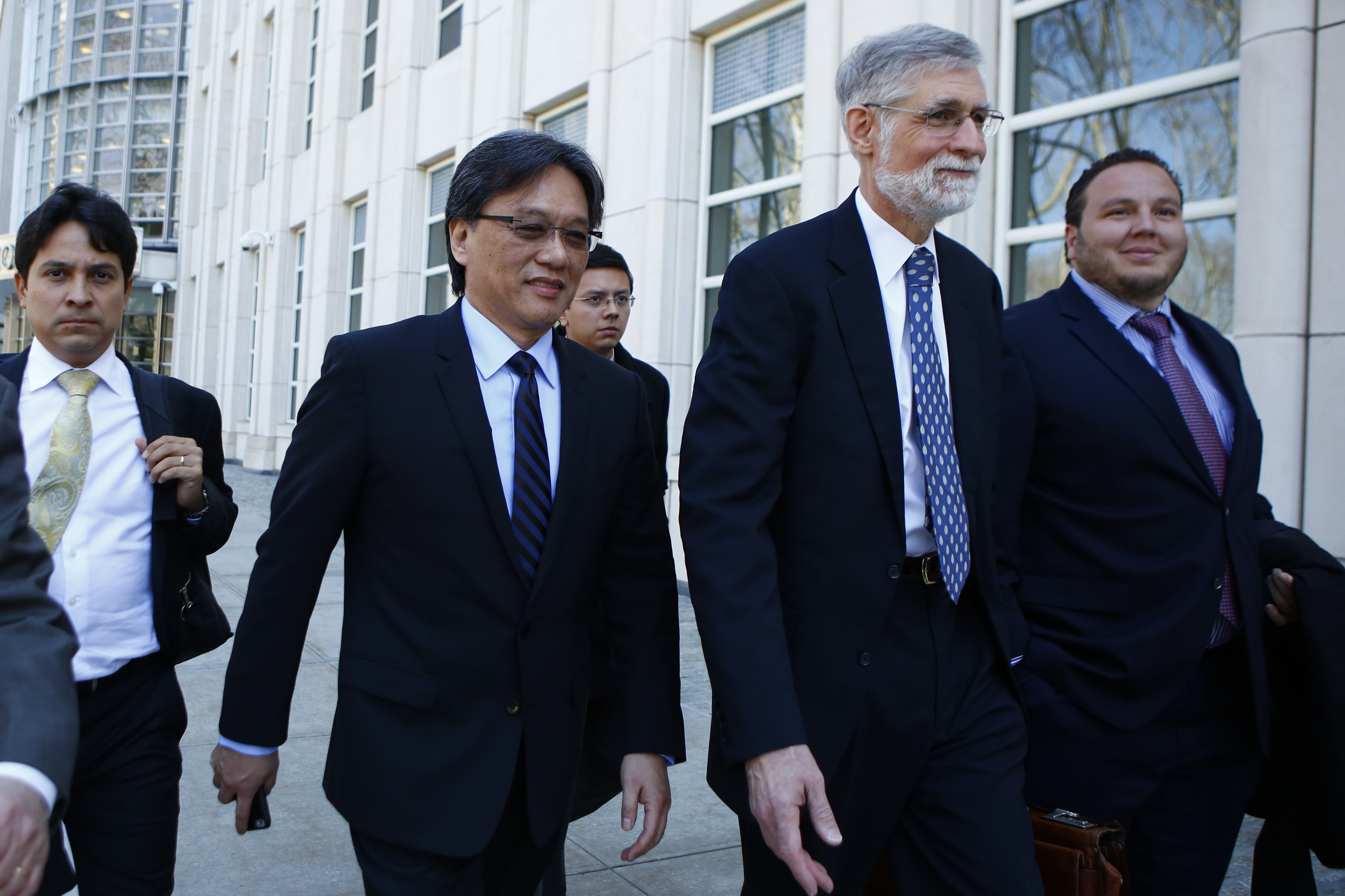 Eduardo Li(2ndL) of Costa Rica, leaves the Court of the Eastern District in Brooklyn New York on April 13, 2016.
The US federal judge overseeing the sweeping FIFA corruption scandal said Wednesday that he would rule within days whether to set a date for trial while evidence still pours in.
The legal team of Costa Rica's Eduardo Li proposed at least a one-month delay, estimating that the amount of data in the case ranged from 700 million to 900 million pages. / AFP PHOTO / KENA BETANCUR