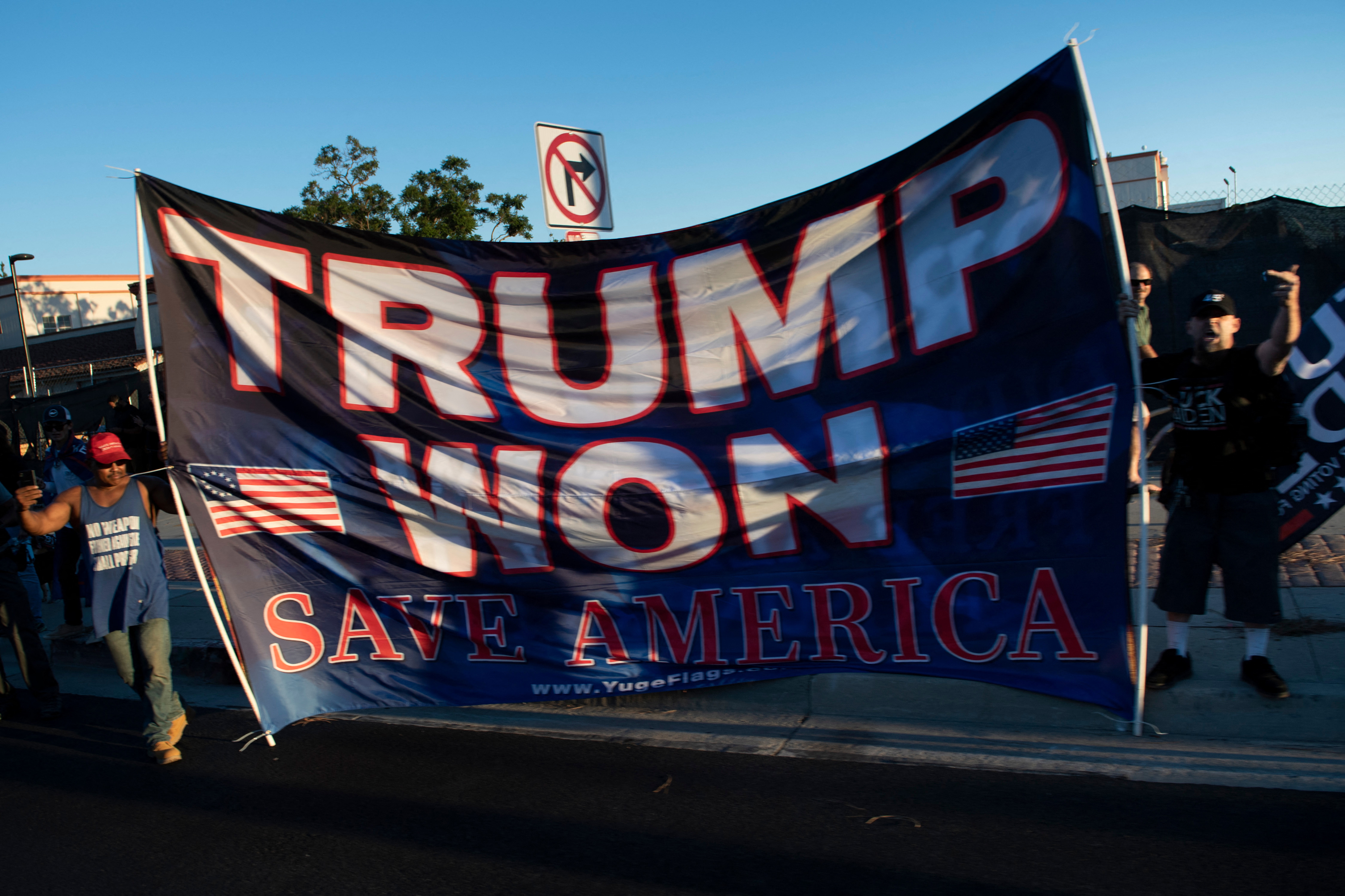 (FILES) In this file photo taken on September 13, 2021 former US President Donald Trump supporters are seen as a motorcade with US President Joe Biden arrives at a campaign event for California Governor Gavin Newsom at Long Beach City Collage in Long Beach, California. - From the Pacific coast to the eastern seaboard, election denialism has seeped from US state capitols into village halls, bars and living rooms -- sickening the US body politic and threatening democracy itself.
Two weeks ahead of the midterm election, Republicans up and down the ballot are embracing defeated president Donald Trump's false assertion that the 2020 election was stolen and that voter fraud is rife. (Photo by Brendan Smialowski / AFP)