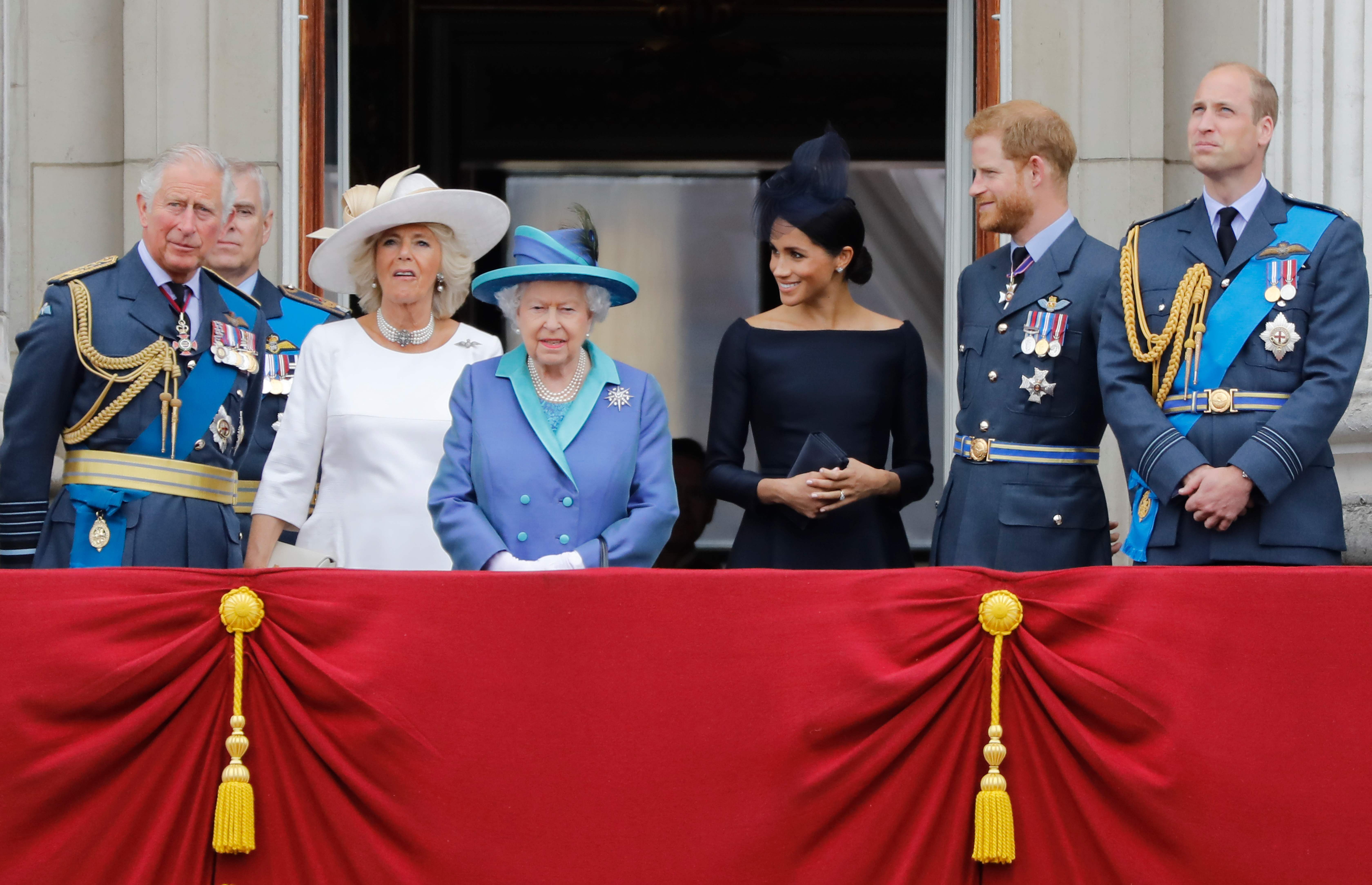 (FILES) In this file photo taken on July 10, 2018 (L-R) Britain's Prince Charles, Prince of Wales, Britain's Camilla, Duchess of Cornwall, Britain's Queen Elizabeth II, Britain's Meghan, Duchess of Sussex, Britain's Prince Harry, Duke of Sussex and Britain's Prince William, Duke of Cambridge stand on the balcony of Buckingham Palace on July 10, 2018 to watch a military fly-past to mark the centenary of the Royal Air Force (RAF). - Queen Elizabeth II will host a showdown meeting with Prince Harry on January 13 in an attempt to solve the crisis triggered by his bombshell announcement that he and wife Meghan were stepping back from the royal frontline. (Photo by Tolga AKMEN / AFP)