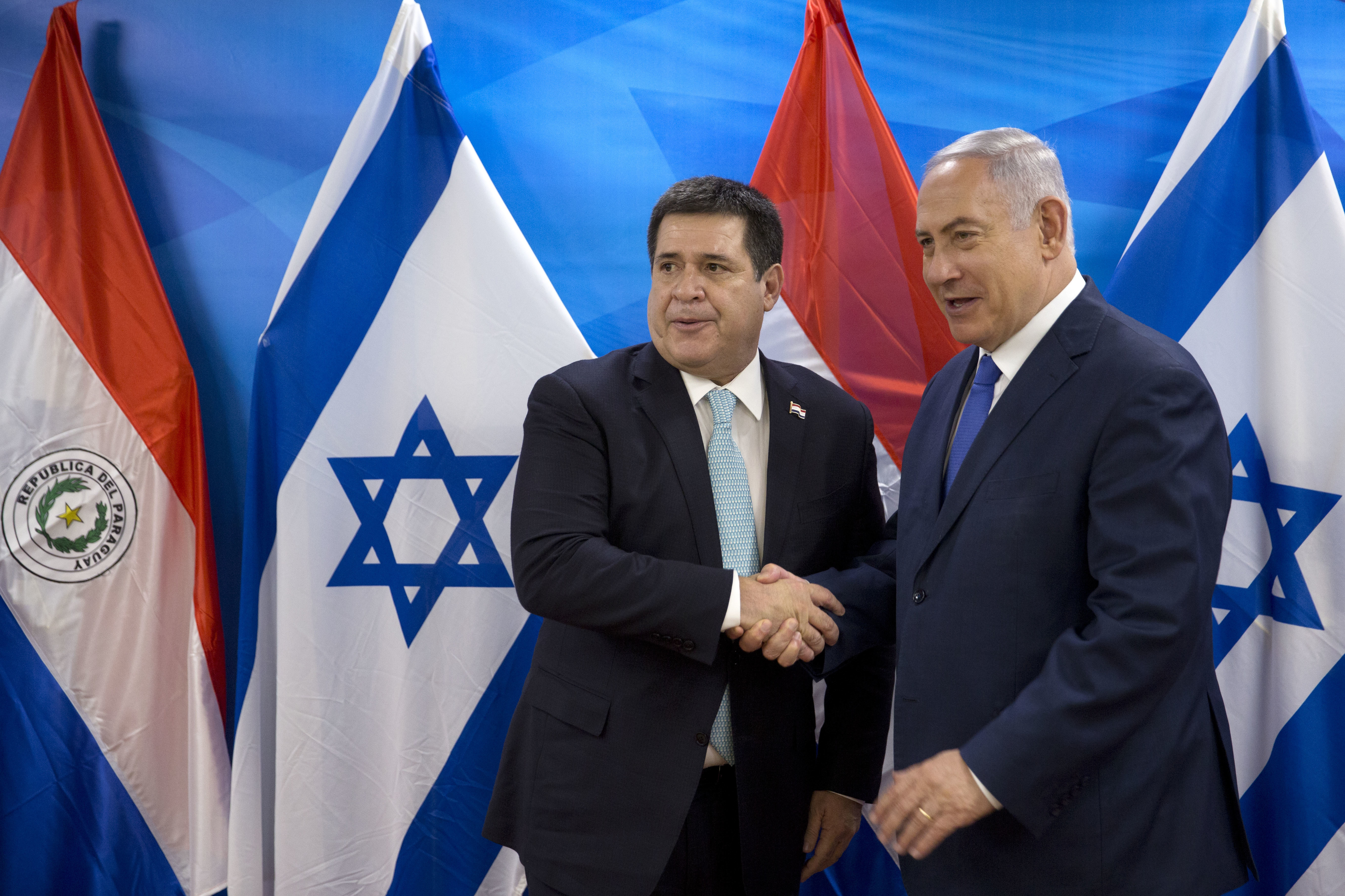 Israeli Prime Minister Benjamin Netanyahu, right, shakes hands with Paraguay's President Horacio Cartes during their meeting at the Prime Minister's office in Jerusalem, Monday, May 21, 2018. Paraguay opened its new embassy in Jerusalem on Monday, following in the footsteps of the United States and Guatemala. (AP Photo/Sebastian Scheiner)