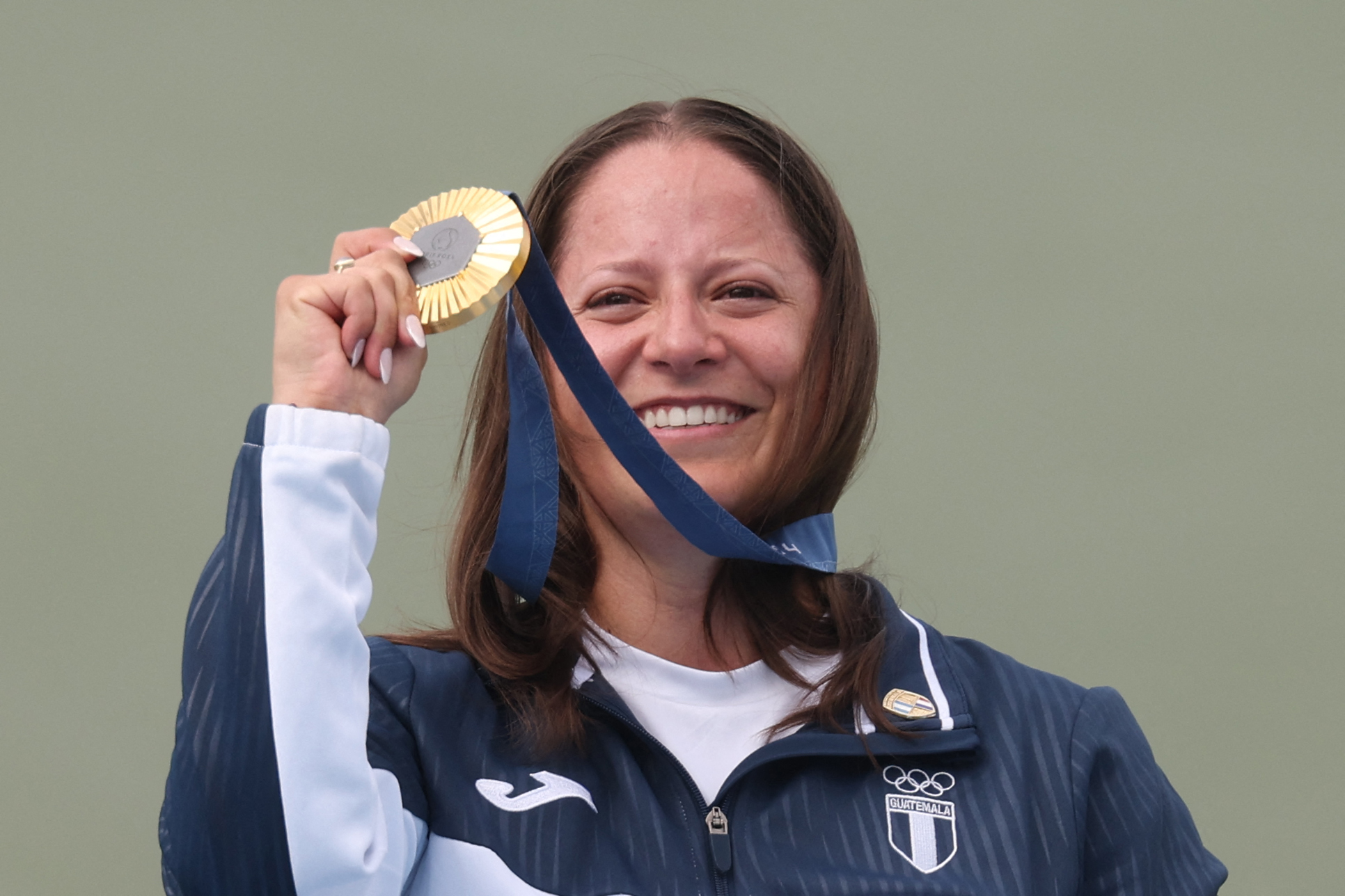 Gold medalist Guatemala's Adriana Ruano Oliva poses on the podium at the end of the shooting trap women's final during the Paris 2024 Olympic Games at Chateauroux Shooting Centre on July 31, 2024. (Photo by Alain JOCARD / AFP)