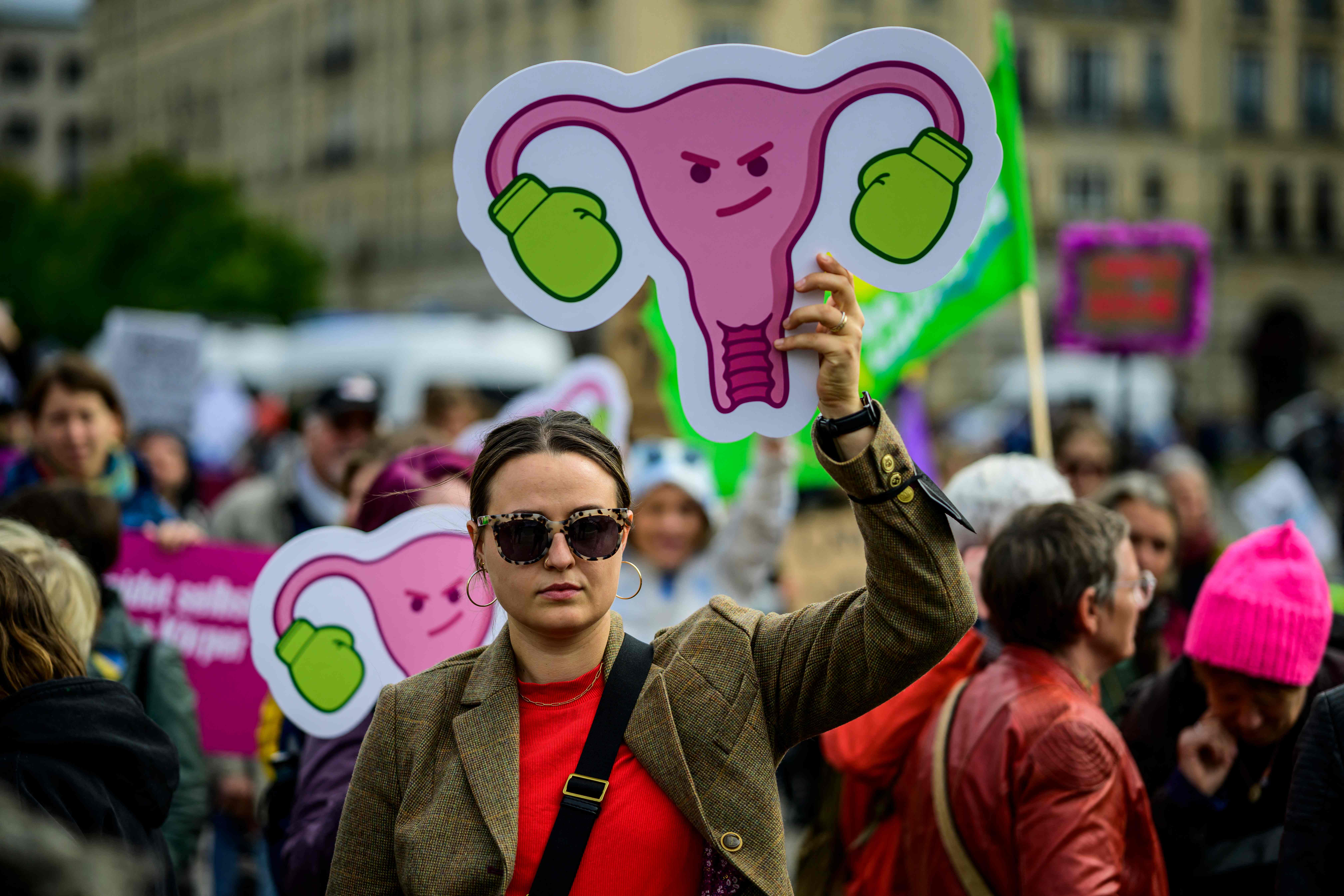 A protester displays a figure representing the internal female genitalia wearing boxing gloves during a pro-choice counter demonstration coinciding with the annual anti-abortion "March for Life" in Berlin on September 17, 2022. (Photo by John MACDOUGALL / AFP)