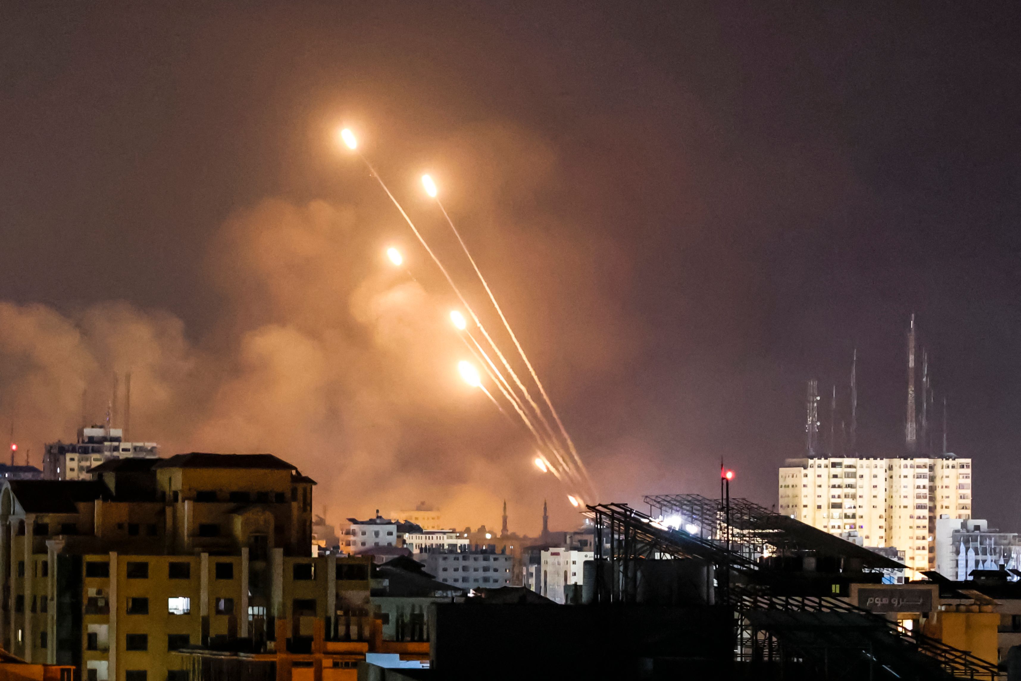 EDITORS NOTE: Graphic content / A salvo of rockets is fired by Palestinian militants from Gaza City toward Israel, on October 8, 2023. The death toll surged to almost 1,000 since Palestinian militant group Hamas launched its massive surprise attack on Israel with a barrage of rockets and a massive ground assault, officials on both sides said on October 8. (Photo by MOHAMMED ABED / AFP)