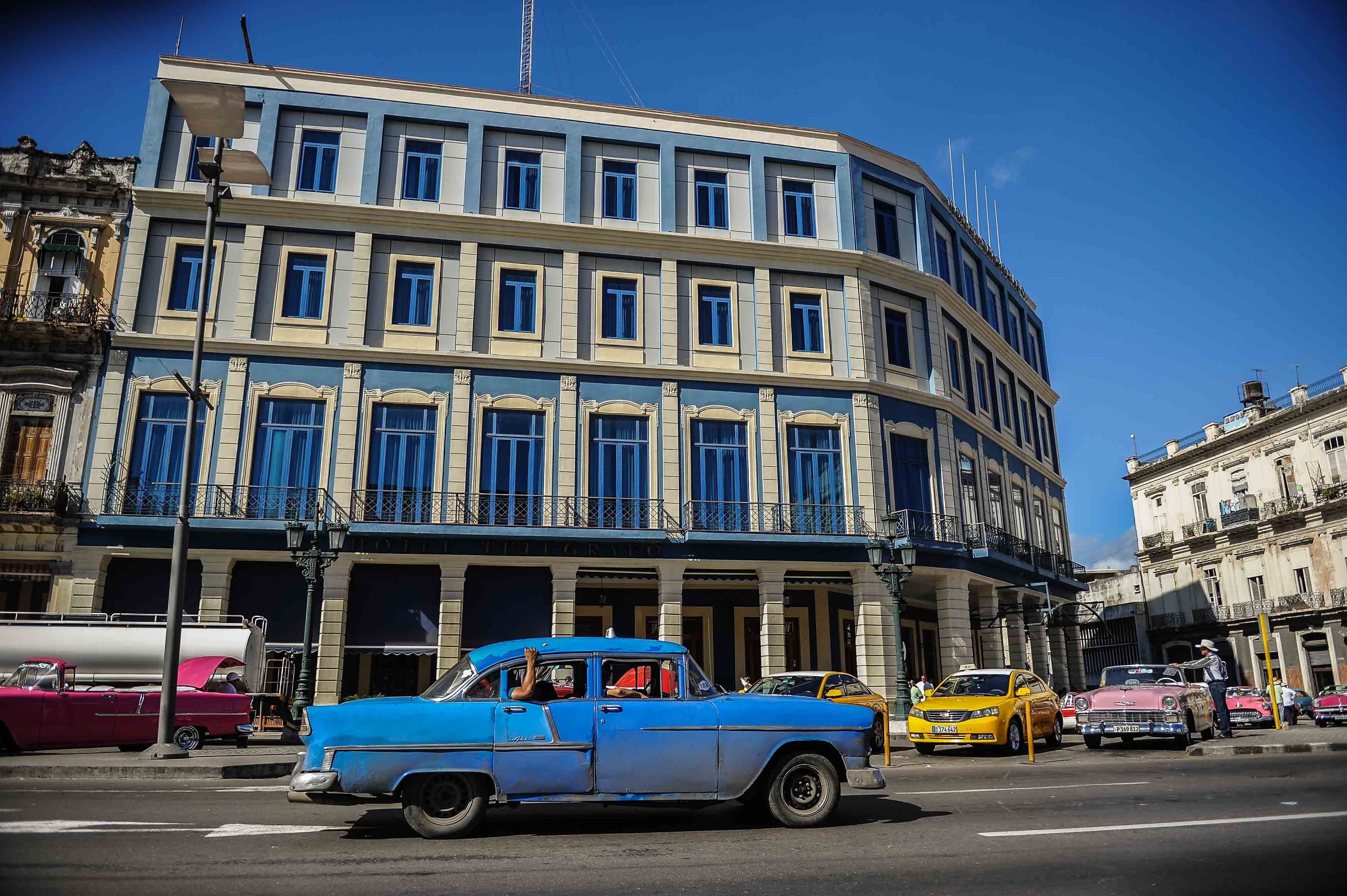 A car passes by the Telegrafo Hotel in Havana on November 8, 2017.
Tighter restrictions on US travellers to Cuba will go into effect on Thursday, officials said, almost five months after President Donald Trump vowed to crack down. The US Treasury said the measures are designed to steer American travellers away from Cuban firms tied to the military and towards the communist island's fledgling private sector. / AFP PHOTO / Yamil LAGE