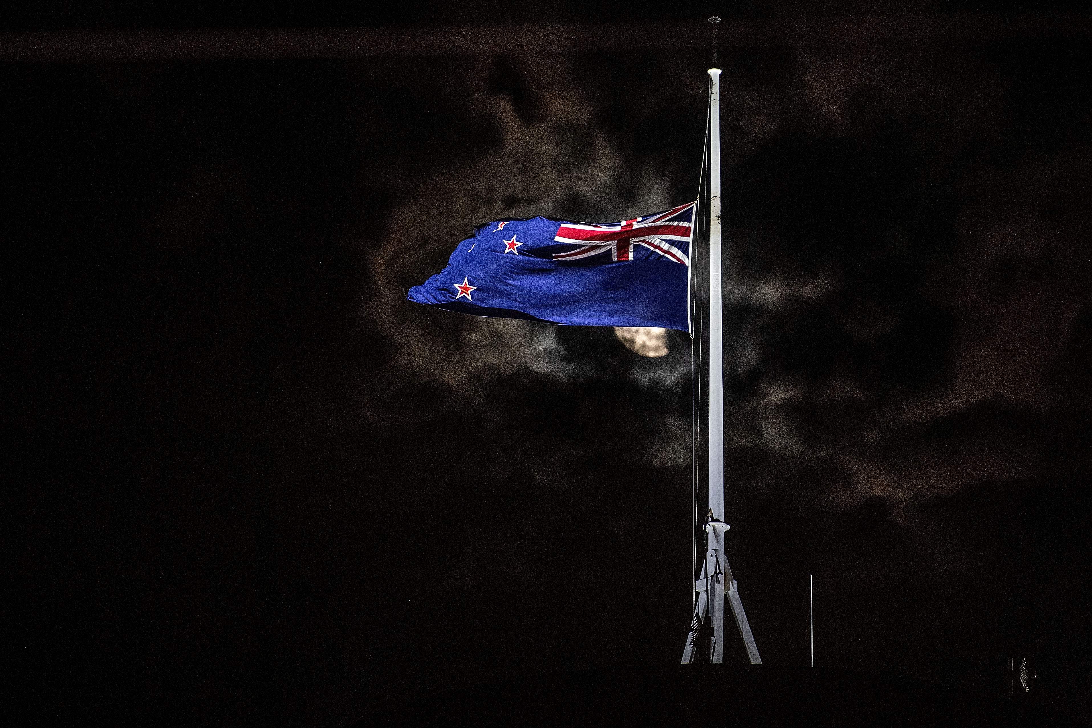 TOPSHOT - The New Zealand national flag is flown at half-mast on a Parliament building in Wellington on March 15, 2019, after a shooting incident in Christchurch. - Attacks on two Christchurch mosques left at least 49 dead on March 15, with one gunman -- identified as an Australian extremist -- apparently livestreaming the assault that triggered the lockdown of the New Zealand city. (Photo by Marty MELVILLE / AFP)