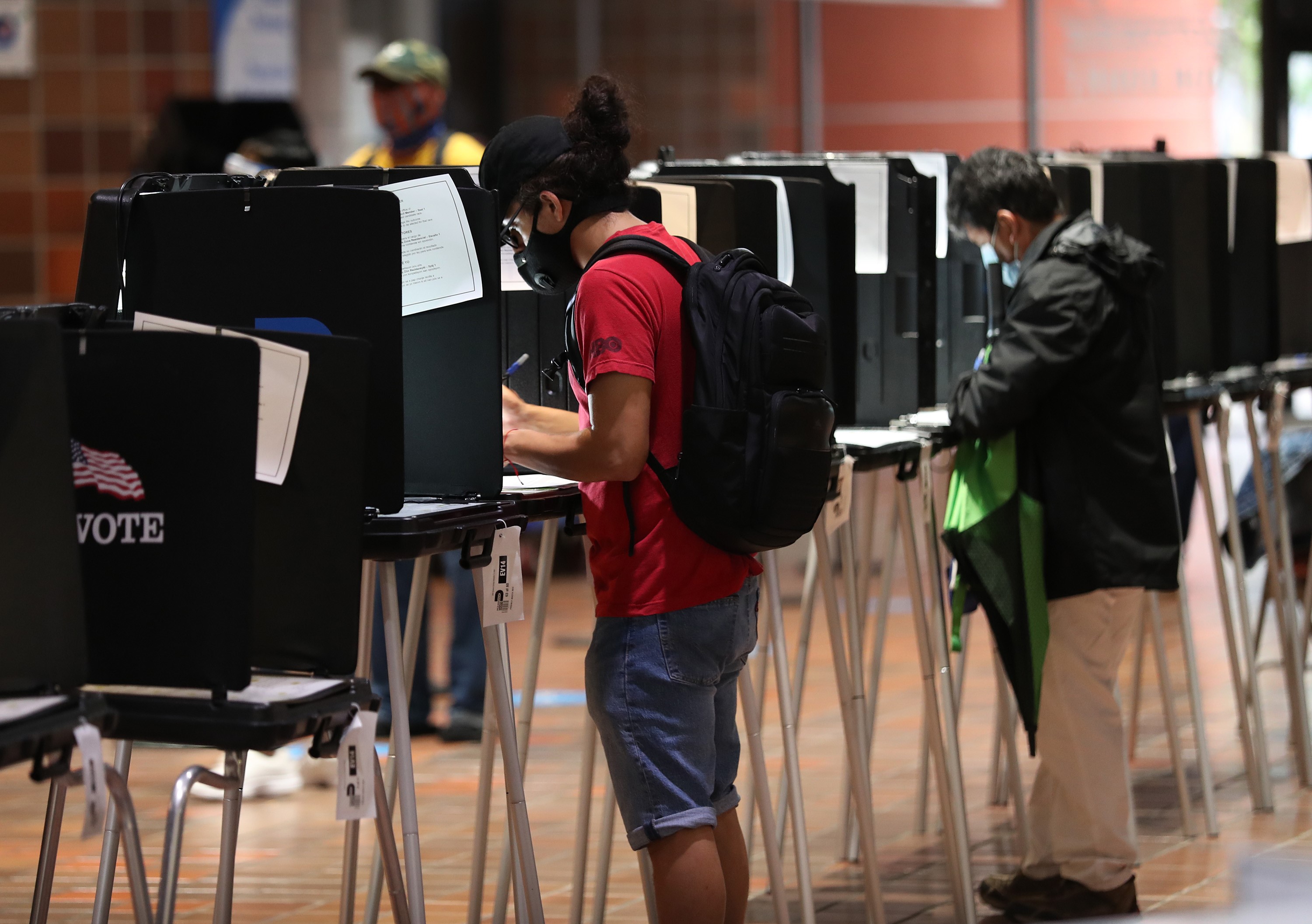MIAMI, FLORIDA - OCTOBER 21: Voters fill out their ballots as they vote at the Stephen P. Clark Government Center polling station on October 21, 2020 in Miami, Florida. The state of Florida saw a record-breaking first day of early voting with over 3.1 million votes cast. The early voting ends on Nov. 1. Voters are casting their ballots for presidential candidates President Donald Trump and Democratic presidential nominee Joe Biden. Joe Raedle/Getty Images/AFP
== FOR NEWSPAPERS, INTERNET, TELCOS & TELEVISION USE ONLY ==