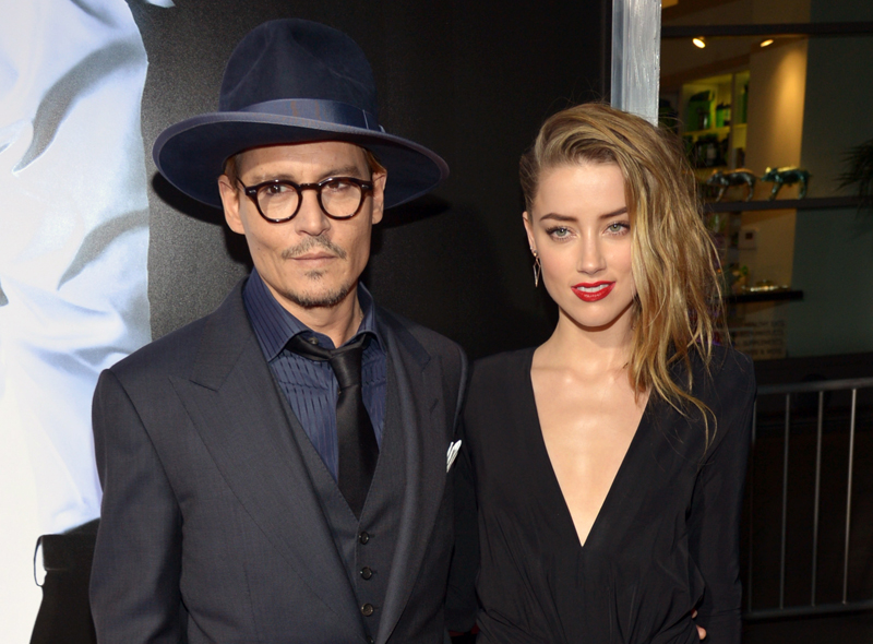 FILE - This Feb. 12, 2014 file photo shows Johnny Depp, left, and Amber Heard at the US premiere of "3 Days to Kill" at ArcLight Cinemas Hollywood in Los Angeles. Depp showed off a diamond engagement ring that he called a "chick's ring" on Monday, March 31, indirectly confirming rumors of his engagement to actress Amber Heard. His comments follow months of unconfirmed reports of his engagement to actress Heard, 27, who starred alongside Kevin Costner in "3 Days to Kill" released in the U.S. earlier this year. (Photo by John Shearer/Invision/AP, File)