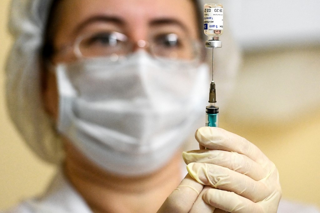 A nurse wearing a face mask fills a syringe with Sputnik V (Gam-COVID-Vac) before proceeding to a vaccination against the coronavirus disease (COVID-19) at a clinic in Moscow on December 5, 2020, amid the ongoing coronavirus disease pandemic. - Russian President has told authorities to begin "large-scale" vaccinations among at-risk populations. The drugs should be made generally available to the Russian public in early 2021. (Photo by Kirill KUDRYAVTSEV / AFP)
