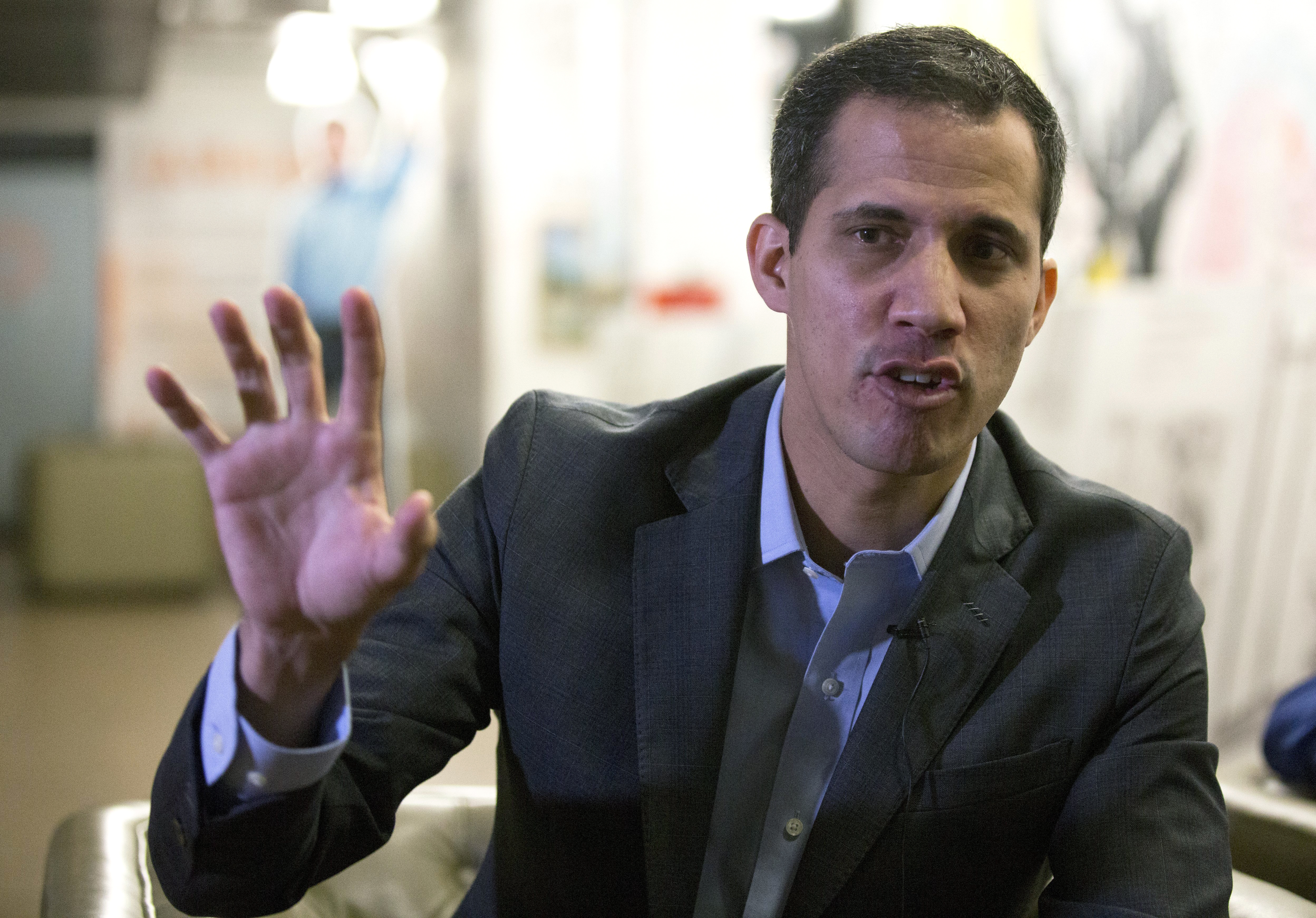 Juan Guaido, opposition leader and president of Venezuela's National Assembly, gives an interview at his office in Caracas, Venezuela, Wednesday, Jan. 9, 2019. Guaido dismissed a threat by the pro-government National Constituent Assembly to investigate opposition lawmakers for treason. (AP Photo/Fernando Llano)