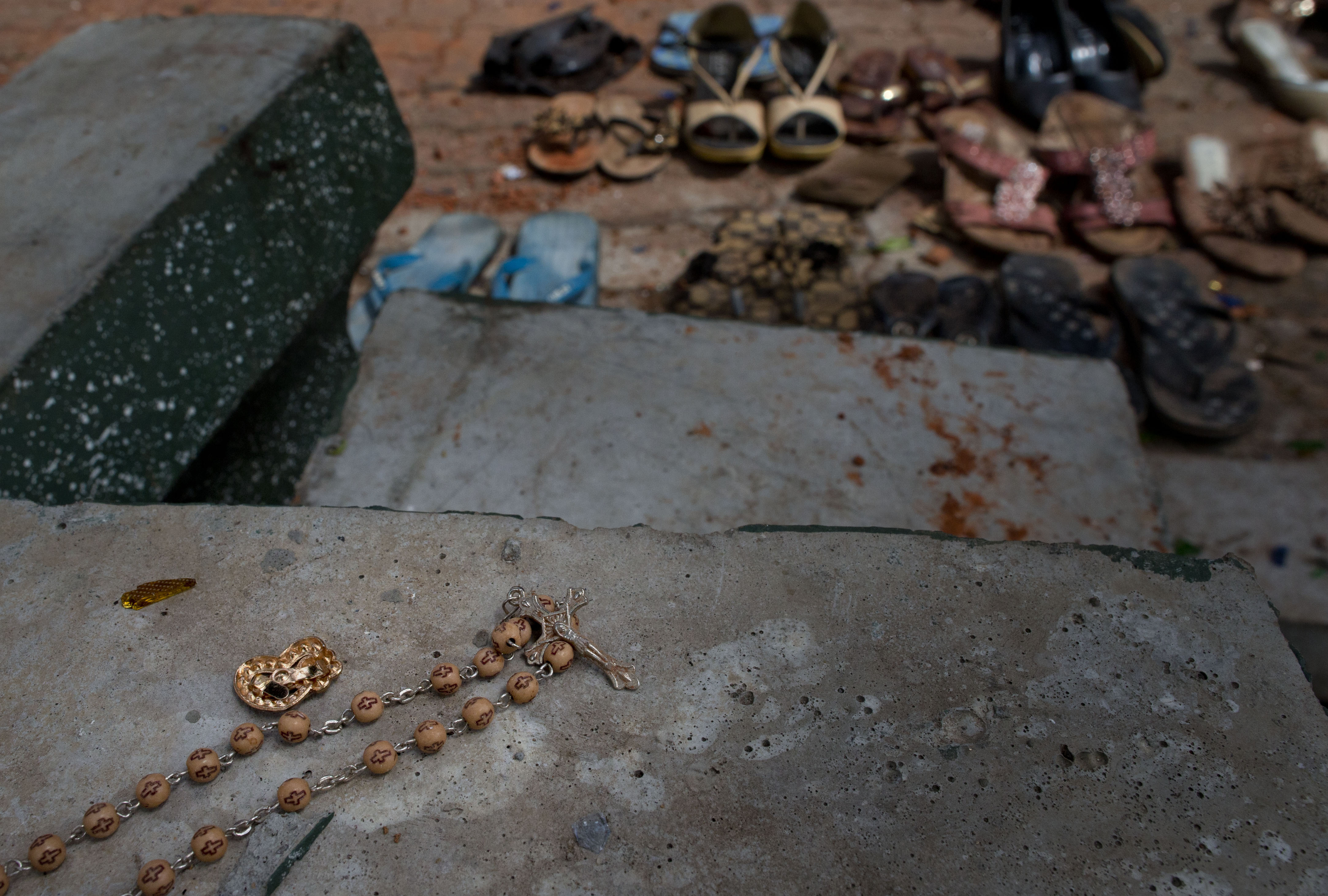 Footwear and personal belongs of victims kept close to the scene of a suicide bombing at St. Sebastian Church in Negombo, Sri Lanka, Monday, April 22, 2019. Easter Sunday bombings of churches, luxury hotels and other sites was Sri Lanka's deadliest violence since a devastating civil war in the South Asian island nation ended a decade ago. (AP Photo/Gemunu Amarasinghe)