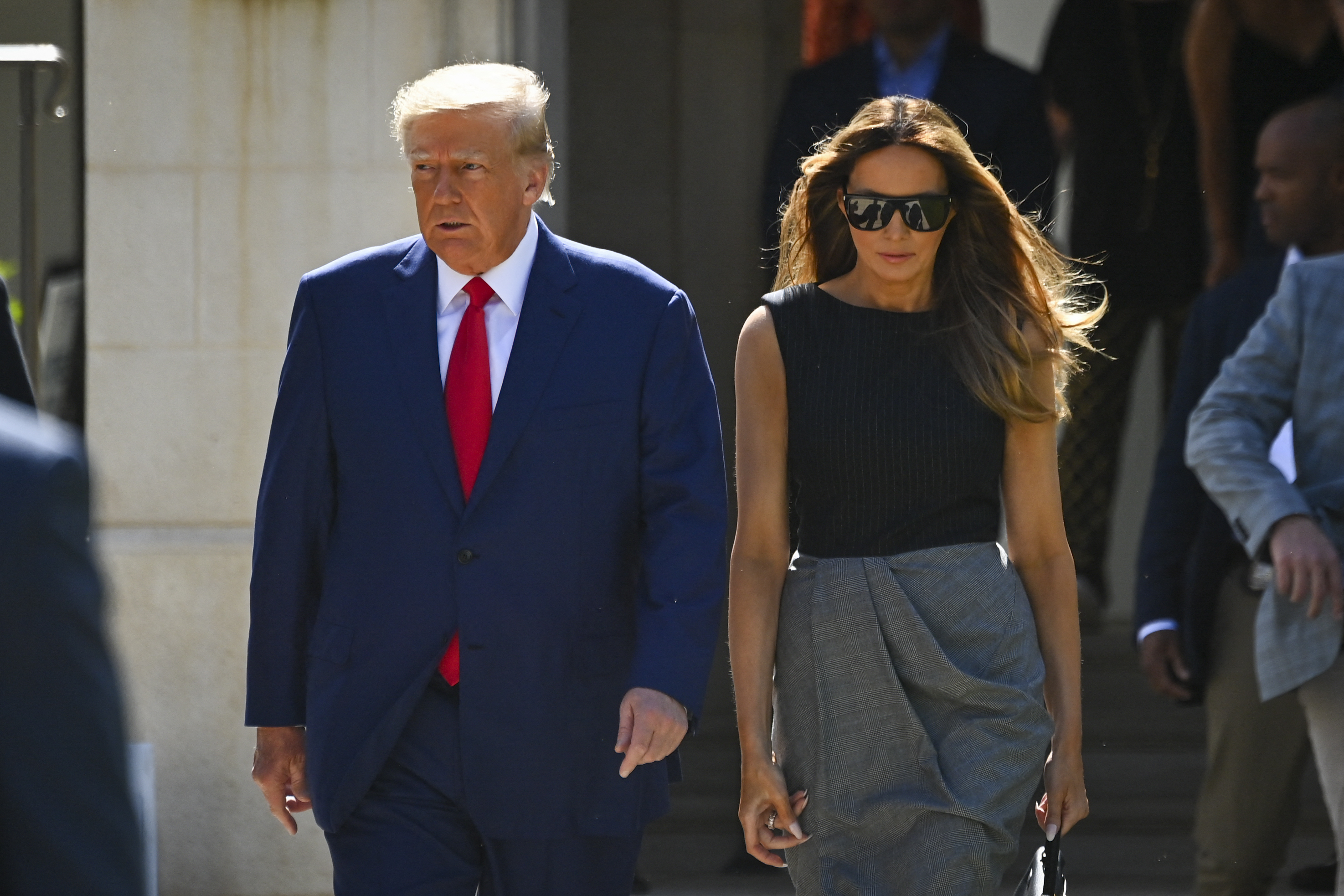 Former US President Donald Trump and his wife, Melania Trump, leave a polling station after voting in the US midterm elections in Palm Beach, Florida, on November 8, 2022. (Photo by Eva Marie UZCATEGUI / AFP)