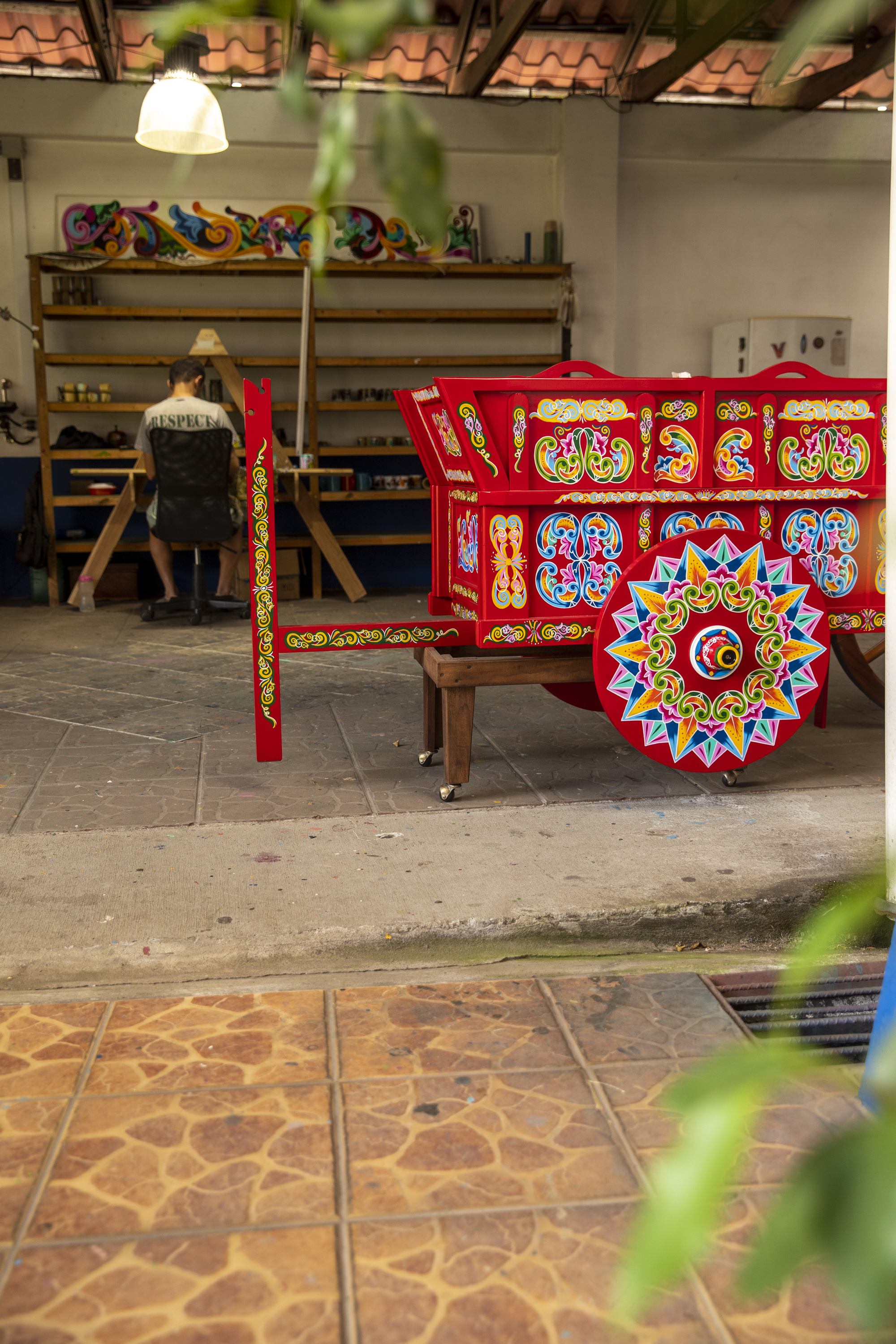 Traditional Sarchí oxcart being restored by an artisan