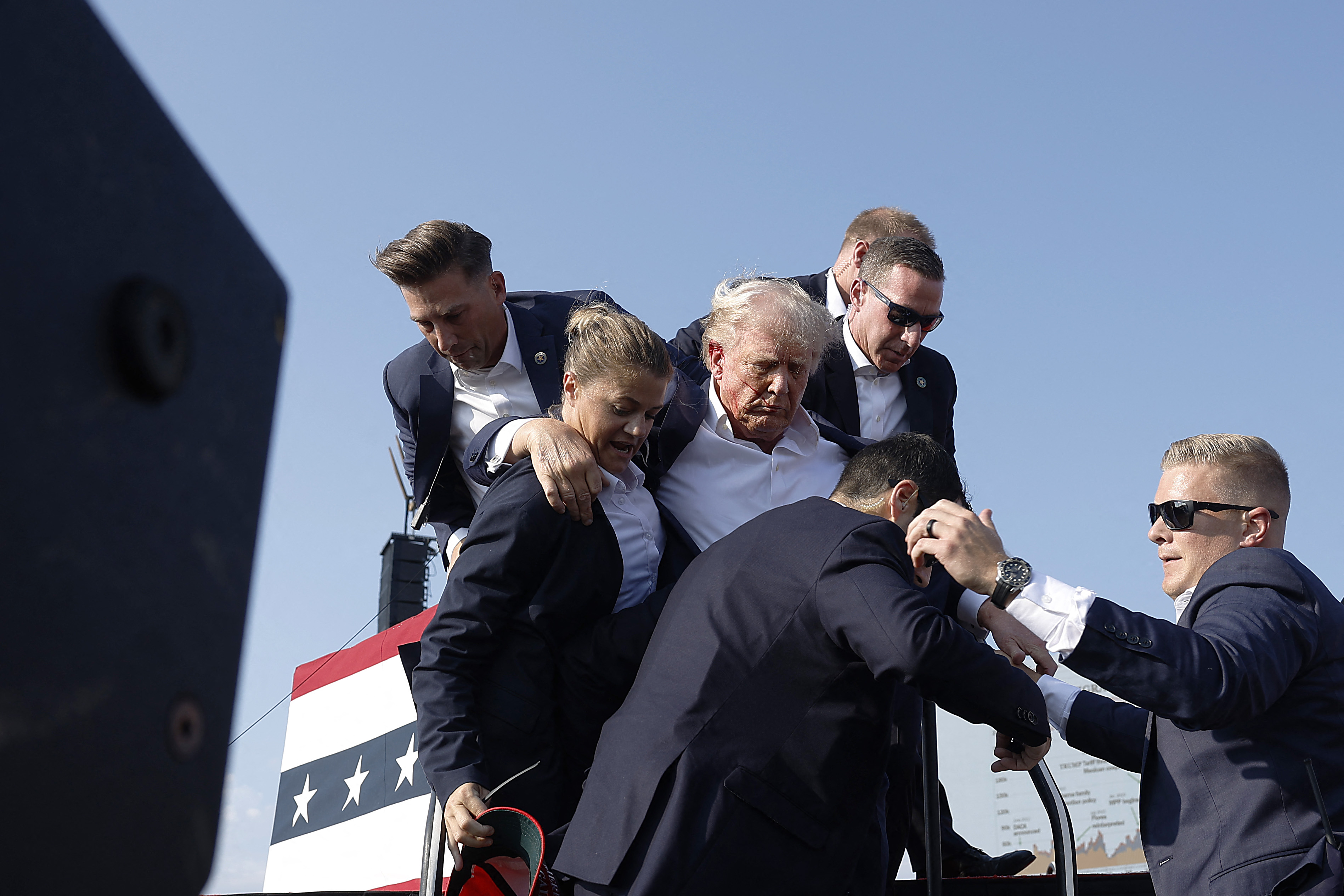 TOPSHOT - BUTLER, PENNSYLVANIA - JULY 13: Republican presidential candidate former President Donald Trump pumps his fist as he is rushed offstage during a rally on July 13, 2024 in Butler, Pennsylvania. Butler County district attorney Richard Goldinger said the shooter is dead after injuring former U.S. President Donald Trump, killing one audience member and injuring another in the shooting. Anna Moneymaker/Getty Images/AFP (Photo by Anna Moneymaker / GETTY IMAGES NORTH AMERICA / Getty Images via AFP)