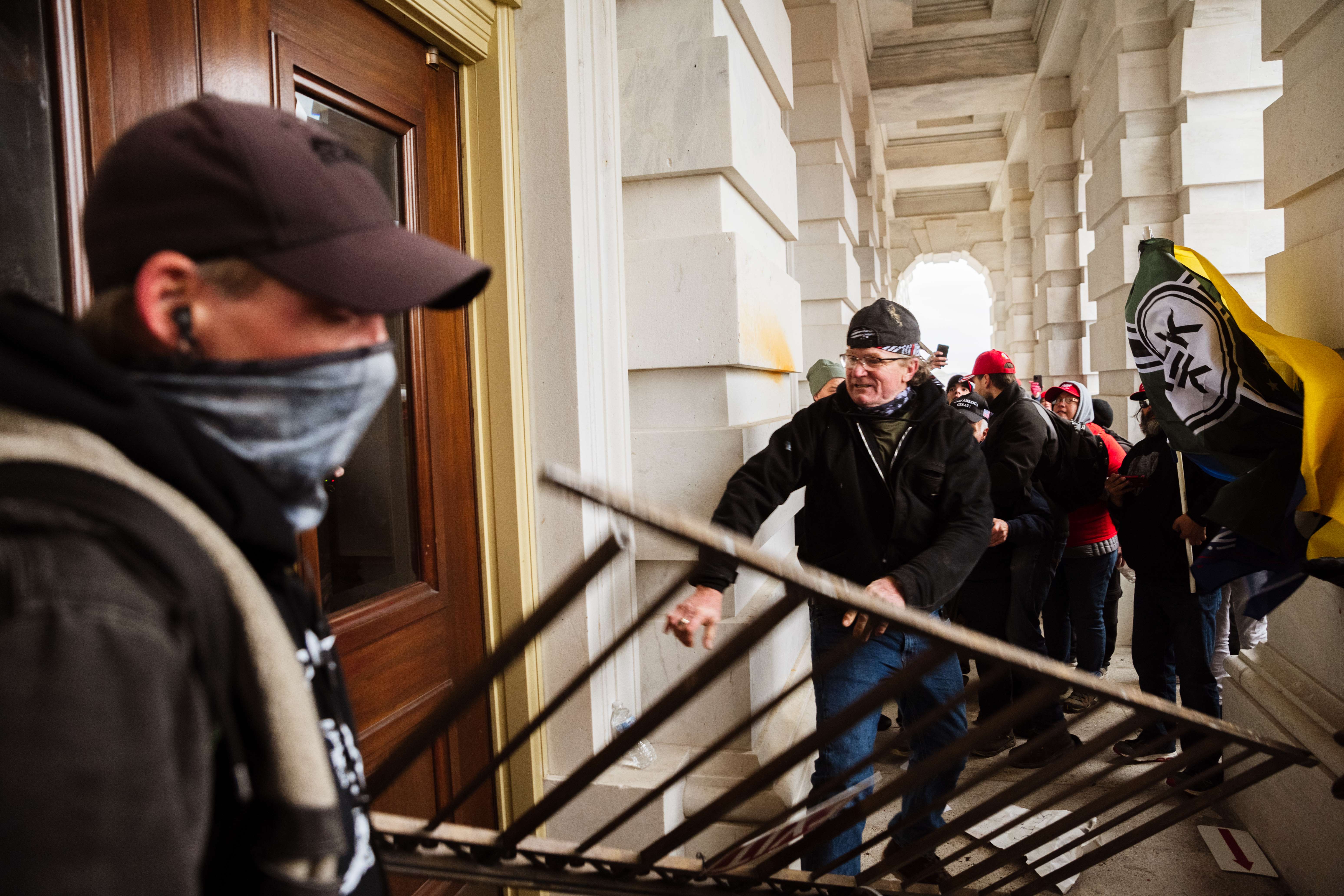 WASHINGTON, DC - JANUARY 06: A member of a pro-Trump mob bashes an entrance of the Capitol Building in an attempt to gain access on January 6, 2021 in Washington, DC. A pro-Trump mob stormed the Capitol, breaking windows and clashing with police officers. Trump supporters gathered in the nation's capital today to protest the ratification of President-elect Joe Biden's Electoral College victory over President Trump in the 2020 election. Jon Cherry/Getty Images/AFP
== FOR NEWSPAPERS, INTERNET, TELCOS & TELEVISION USE ONLY ==