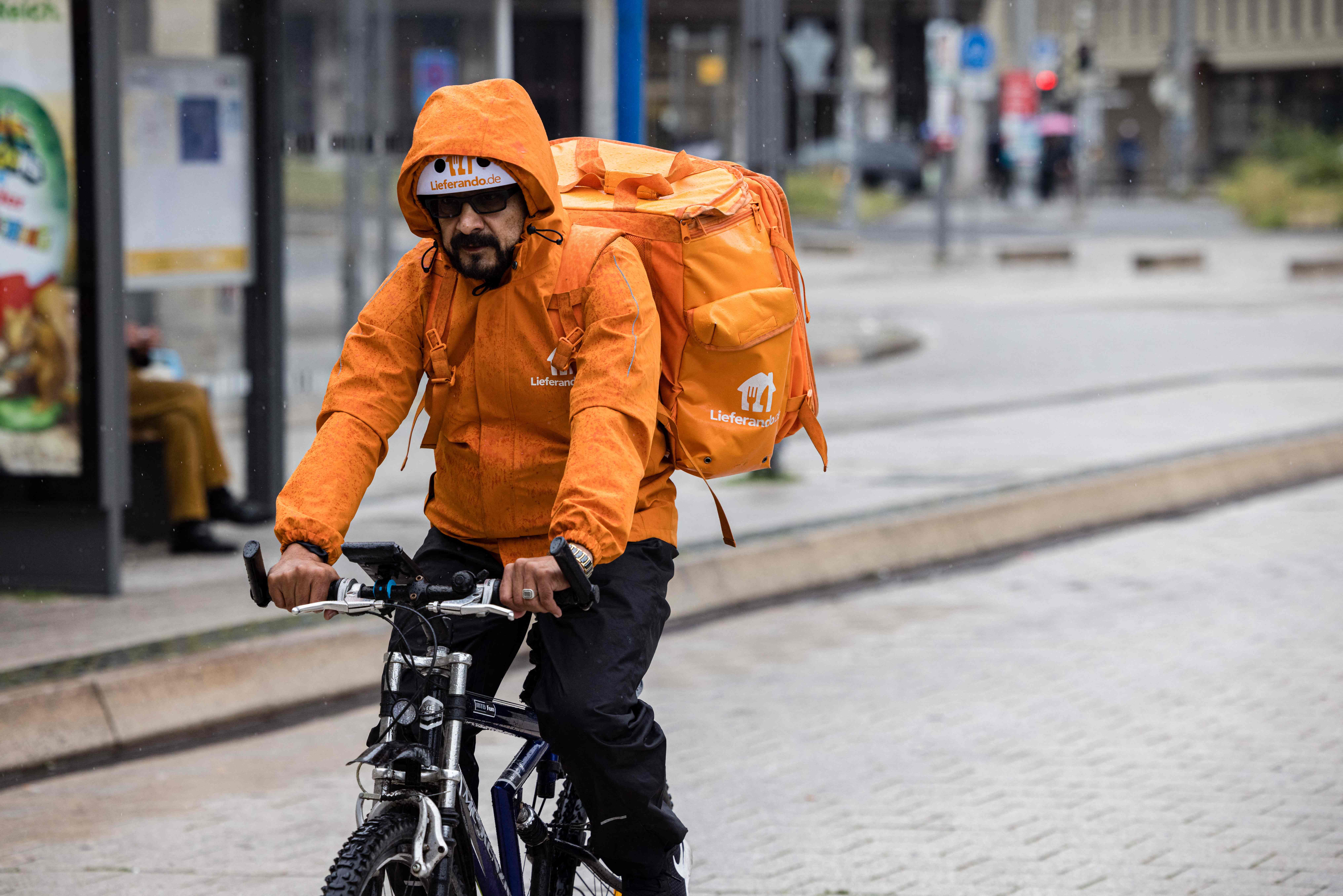 Sayed Sadaat, former communications minister in Afghanistan, poses for a photo in Leipzig, eastern Germany on August 29, 2021. - Sadaat, minister in Afghanistan from 2016 to 2018, quit, fed up with the corruption. Now in Germany, he is making a living delivering meals as a bicycle courier. (Photo by JENS SCHLUETER / AFP) / TO GO WITH AFP STORY by Hui Min NEO