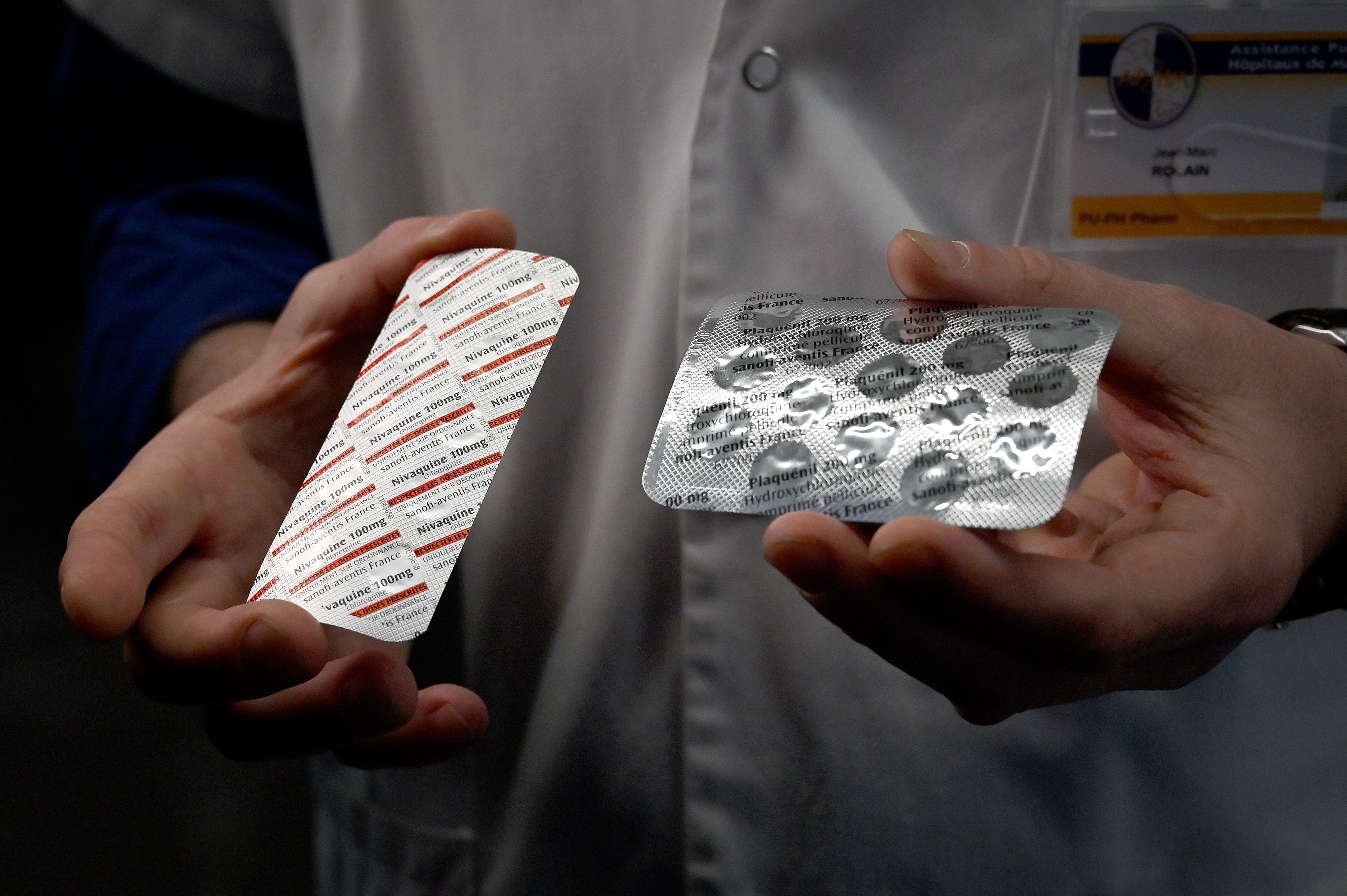 (FILES) In this file photo taken on February 26, 2020 a medical staff shows at the IHU Mediterranee Infection Institute in Marseille, packets of a Nivaquine, tablets containing chloroquine and Plaqueril, tablets containing hydroxychloroquine, drugs that has shown signs of effectiveness against coronavirus. (Photo by GERARD JULIEN / AFP)