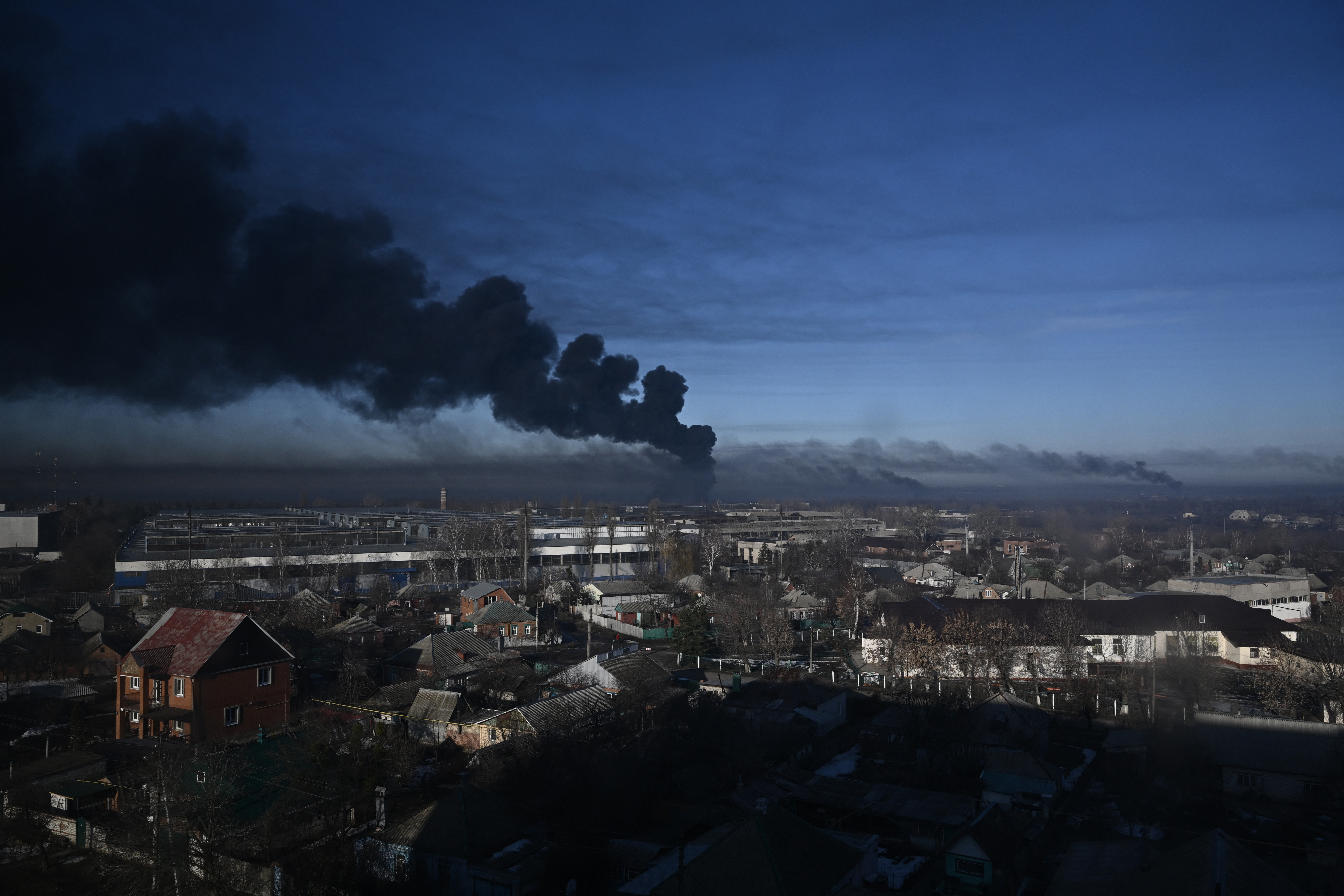 Black smoke rises from a military airport in Chuguyev near Kharkiv on February 24, 2022. - Russian President Vladimir Putin announced a military operation in Ukraine today with explosions heard soon after across the country and its foreign minister warning a "full-scale invasion" was underway. (Photo by Aris Messinis / AFP)