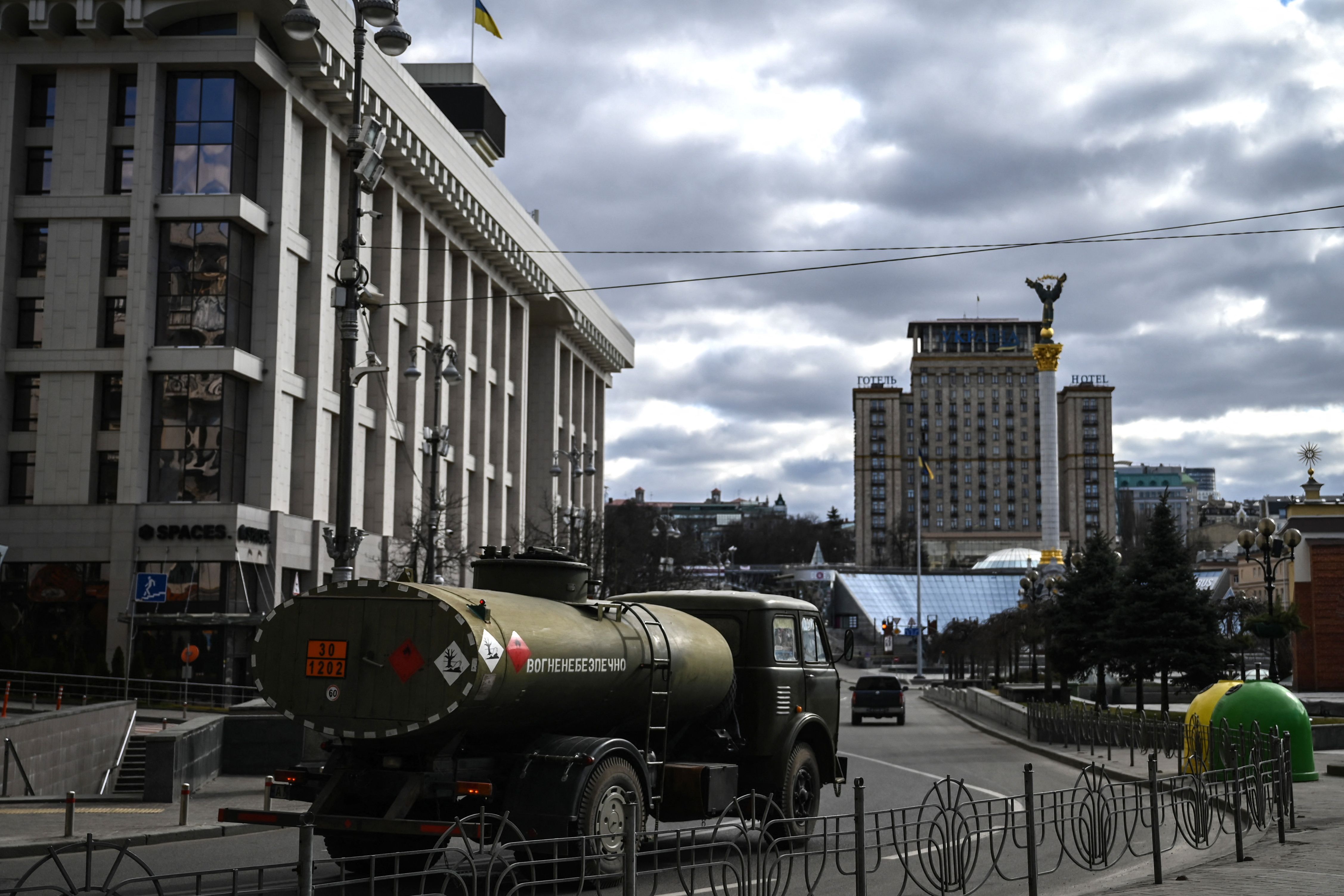 A military vehicle drives through Maidan square in Kyiv, on February 27, 2022. - Kyiv authorities on February 26, 2022 toughened curfew orders in the city, saying violators would be considered "enemy" saboteurs as Russian forces press to capture Ukraine's capital. (Photo by Aris Messinis / AFP)