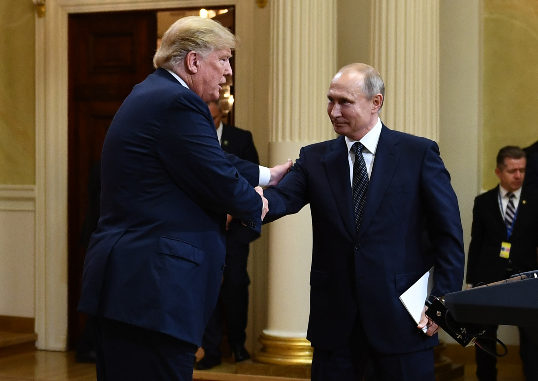 US President Donald Trump and Russia's President Vladimir Putin shake hands after a joint press conference after a meeting at the Presidential Palace in Helsinki, on July 16, 2018. / AFP PHOTO / Brendan Smialowski