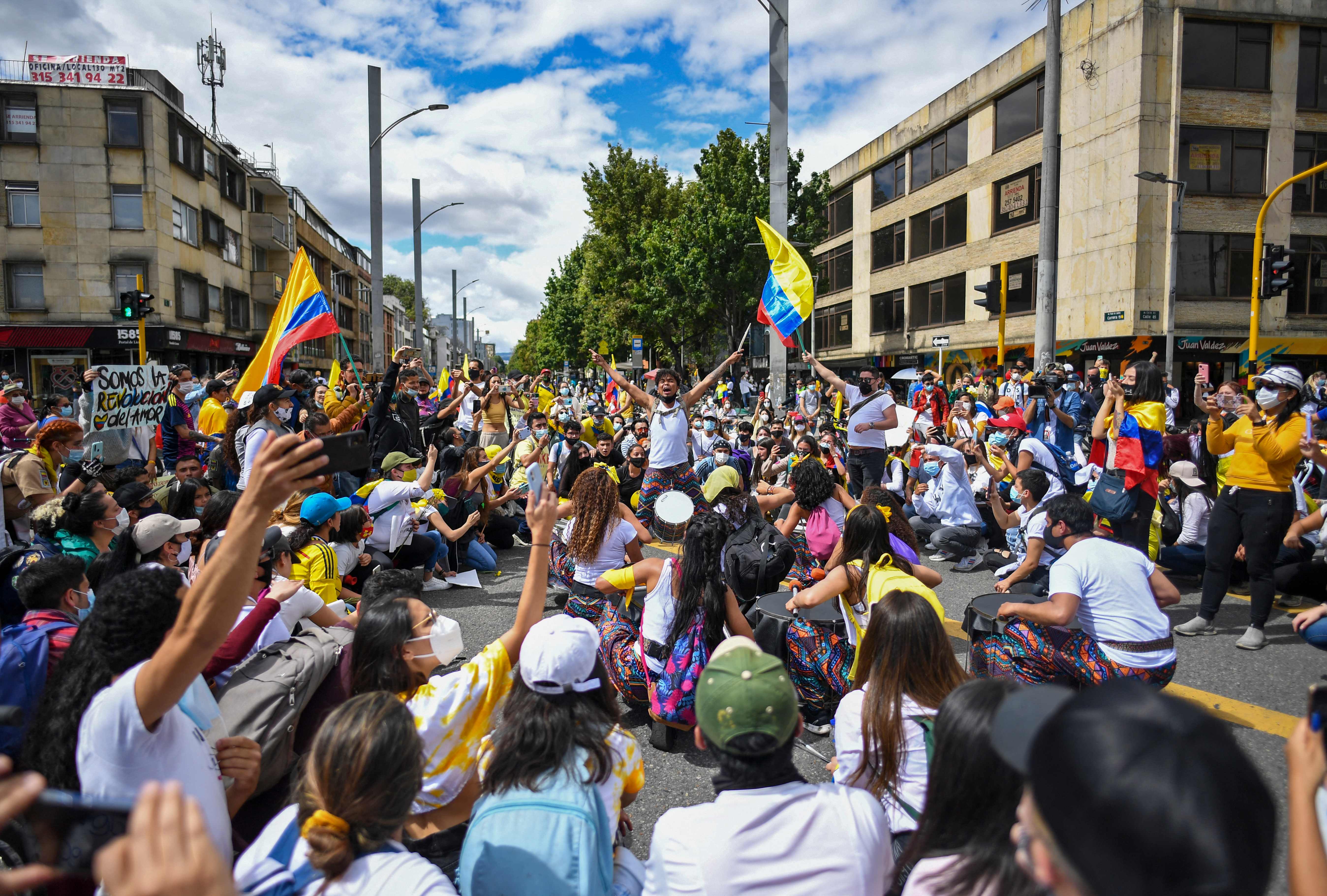 People march during a national strike triggered by a now abandoned tax reform, in Bogota on May 9, 2021. - Facing anti-government protests that have spiraled into deadly violence, Colombian President Ivan Duque is holding a series of talks with his political foes in search of a way out of the crisis. (Photo by Juan BARRETO / AFP)