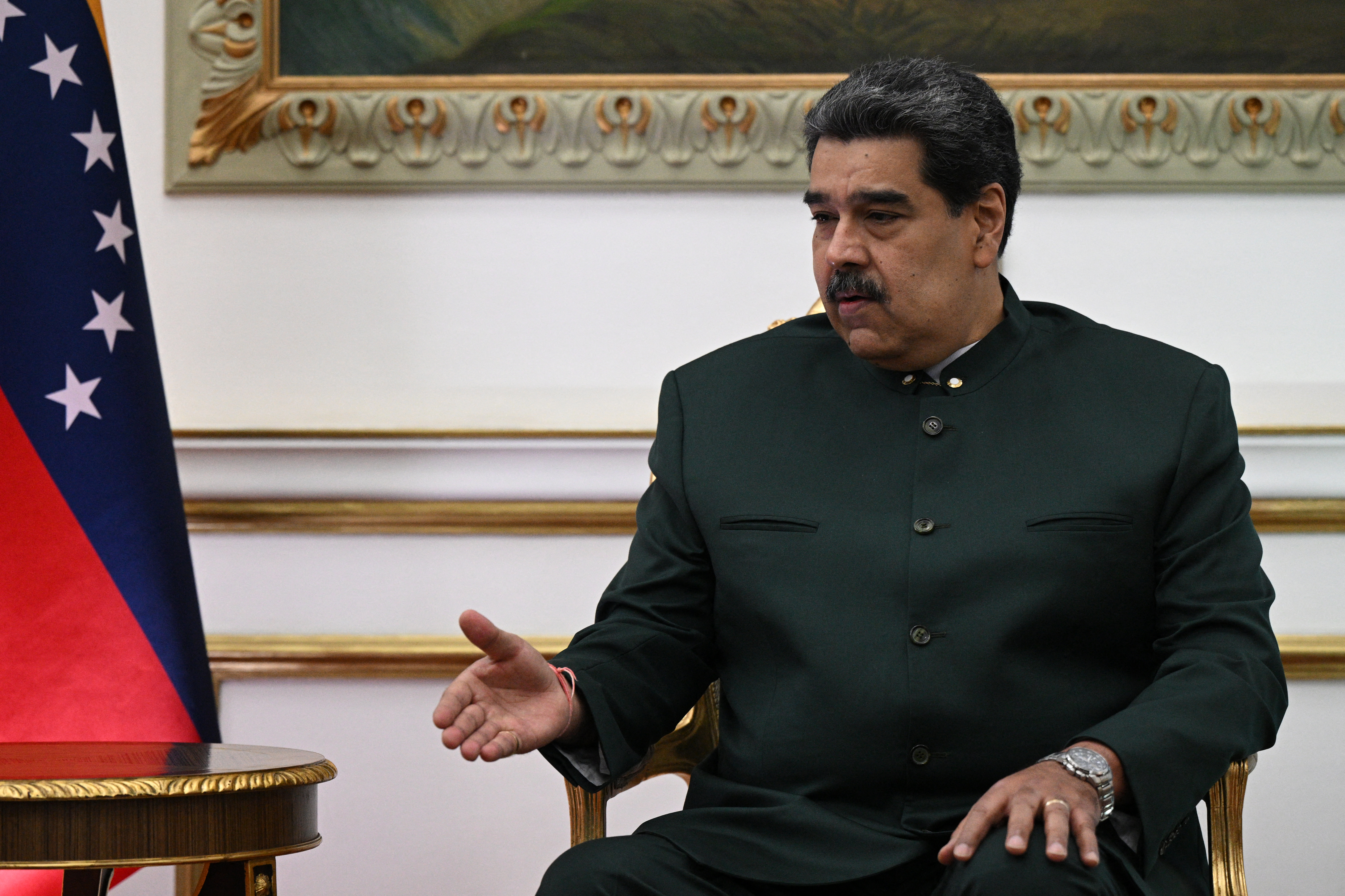 Venezuela's President Nicolas Maduro gestures during a meeting with the Secretary General of the Organization of the Petroleum Exporting Countries (OPEC), Kuwaiti Haitham al-Ghais (out of frame), at the Miraflores presidential palace in Caracas, on September 14, 2022. (Photo by Federico Parra / AFP)