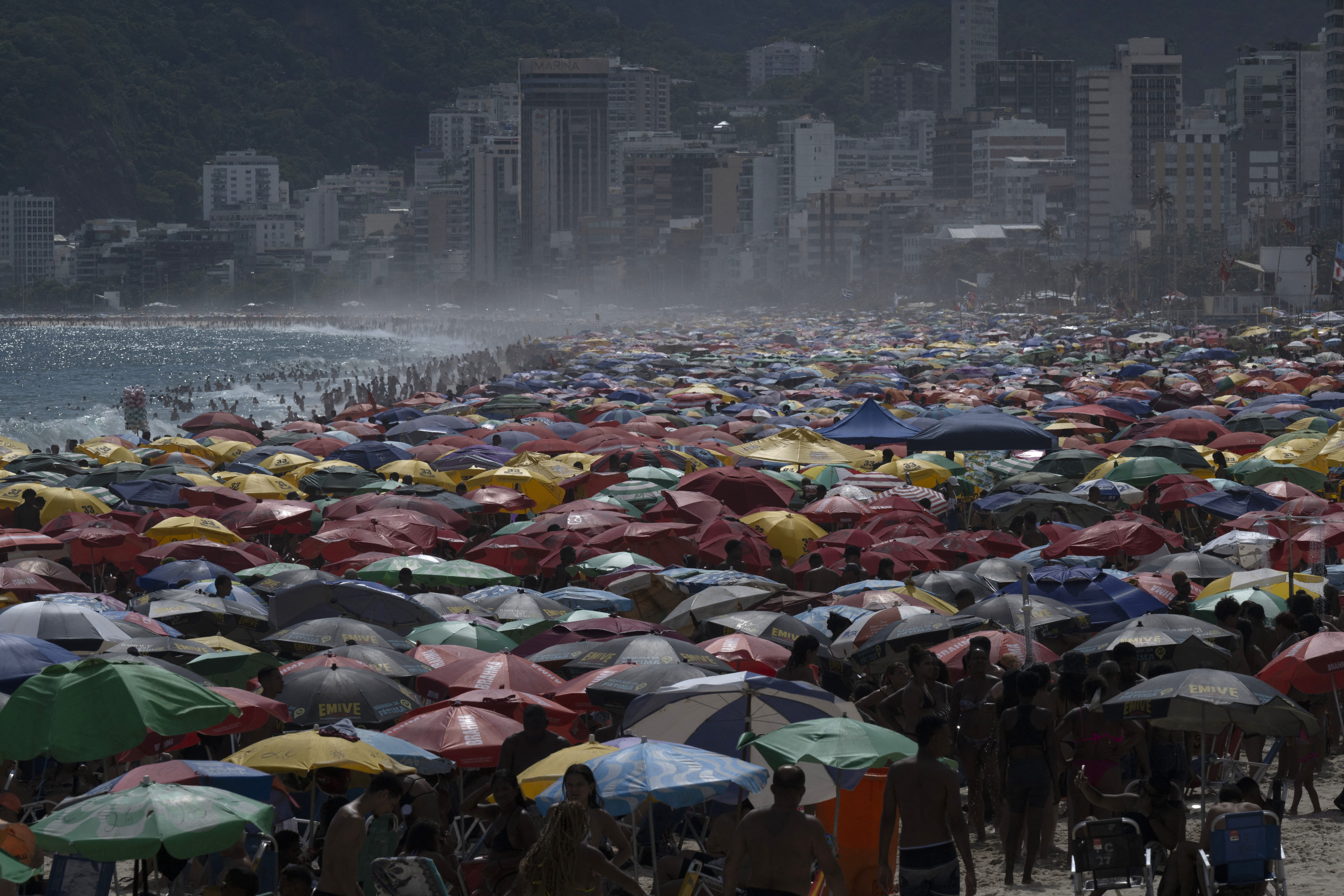 View of people enjoying Ipanema beach in Rio de Janeiro, Brazil, on February 9, 2025. (Photo by Pablo PORCIUNCULA / AFP)