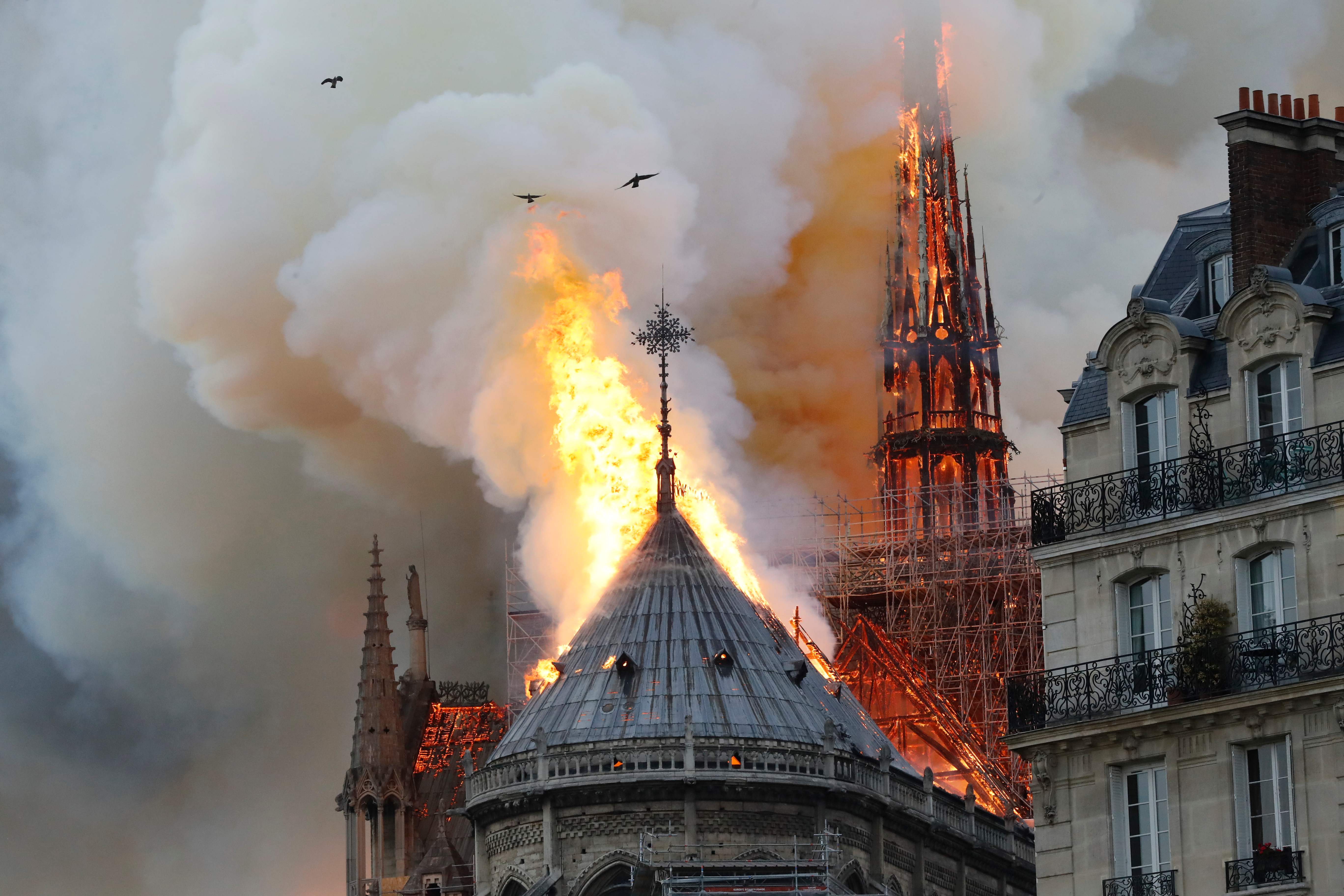 Smoke and flames rise during a fire at the landmark Notre-Dame Cathedral in central Paris on April 15, 2019, potentially involving renovation works being carried out at the site, the fire service said. (Photo by FRANCOIS GUILLOT / AFP)