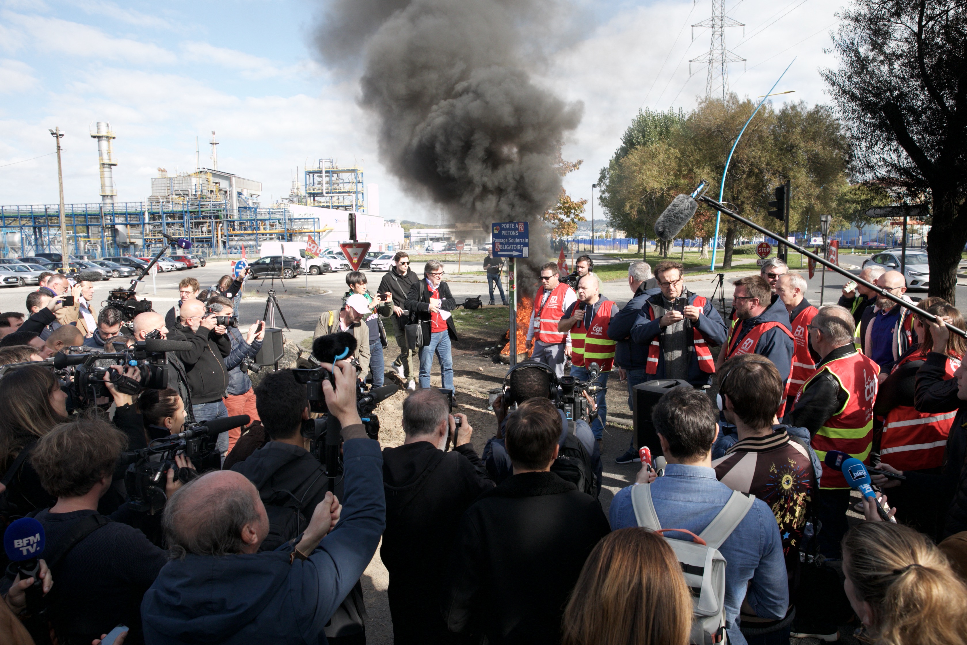 Unionists gather at the Gravenchon-Port-Jerome refinery, owned by US giant Esso-ExxonMobil, on October 12, 2022 in Port-Jerome, Normandy, where fuel depot personnel will be the first to be requisitioned by the government as their strike entered its third week. - Striking French oil refinery employees voted today to maintain blockades now in their third week, despite a government order for some of them to return to work in a bid to get fuel supplies flowing. The industrial action to demand pay hikes has paralysed six out of the seven fuel refineries in France, leading to shortages of petrol and diesel exacerbated by panic-buying from drivers. (Photo by Lou BENOIST / AFP)