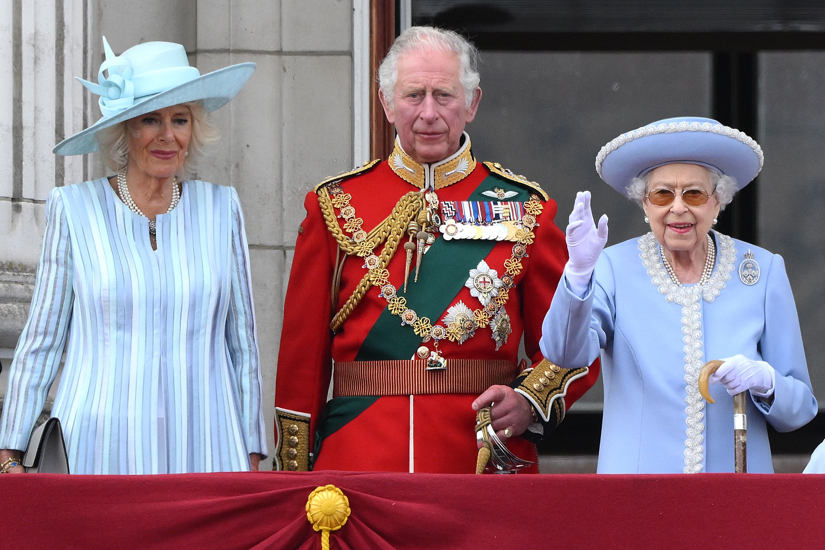 (FILES) In this file photo taken on June 2, 2022 Britain's Queen Elizabeth II (R) stands with Britain's Camilla, Duchess of Cornwall (L) and Britain's Prince Charles, Prince of Wales to watch a special flypast from Buckingham Palace balcony following the Queen's Birthday Parade, the Trooping the Colour, as part of Queen Elizabeth II's platinum jubilee celebrations, in London. - Queen Elizabeth II, the longest-serving monarch in British history and an icon instantly recognisable to billions of people around the world, has died aged 96, Buckingham Palace said on September 8, 2022. Her eldest son, Charles, 73, succeeds as king immediately, according to centuries of protocol, beginning a new, less certain chapter for the royal family after the queen's record-breaking 70-year reign. (Photo by Daniel LEAL / AFP)