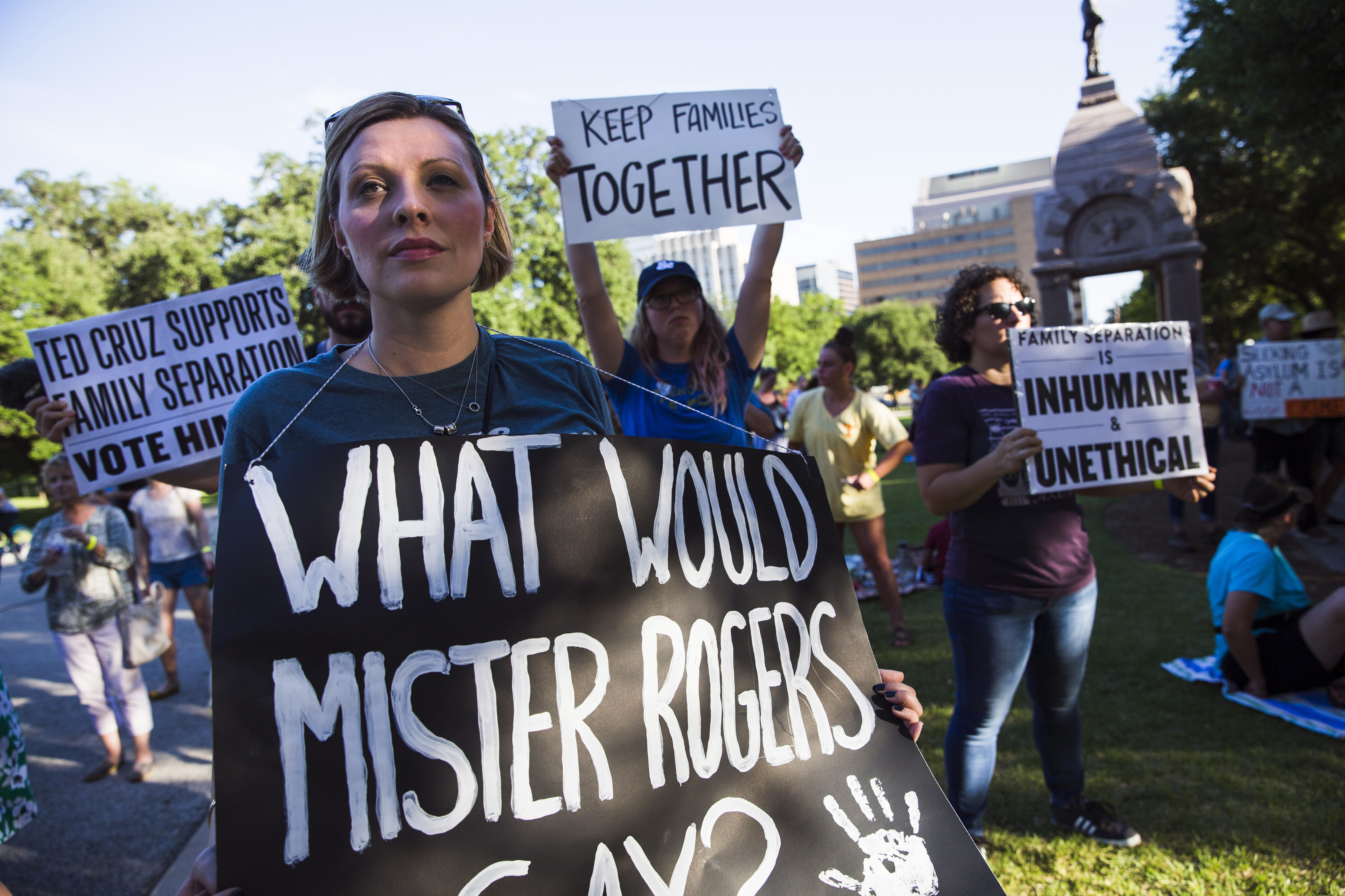 Demonstrators gather to protest against the separation of immigrant families at the border in Austin, on Thursday, June 14, 2018, in Austin, Texas. The U.S. government will open a temporary shelter for unaccompanied immigrant children in far west Texas, as existing facilities for children reach capacity under the Trump administration's "zero tolerance" policy on migrants and the resulting separation of families. (Amanda Voisard/Austin American-Statesman via AP)