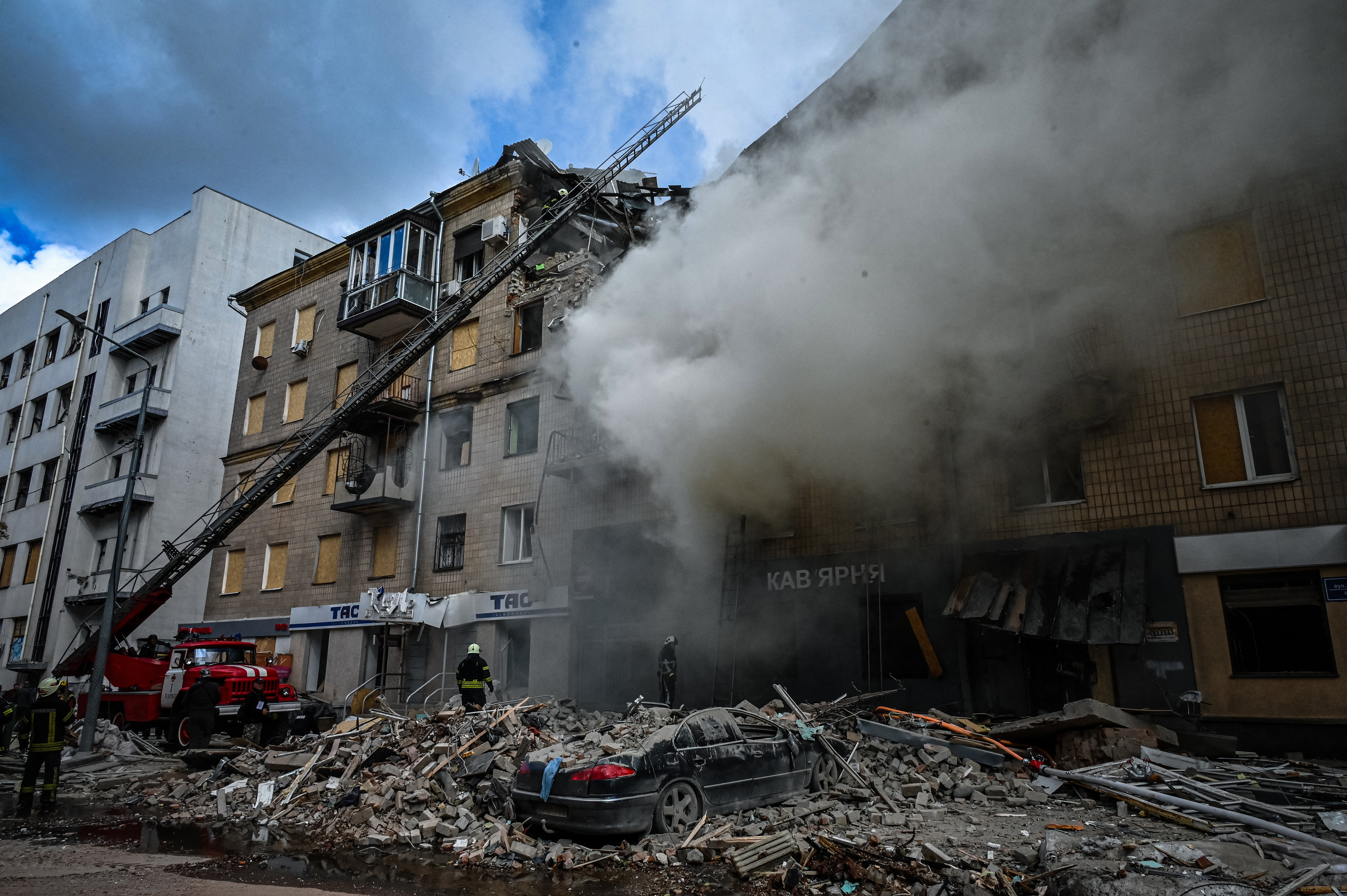 Firefighters extinguish a fire after an apartment was hit by a missile strike in Kharkiv, on September 6, 2022, amid the Russian invasion of Ukraine. (Photo by SERGEY BOBOK / AFP)