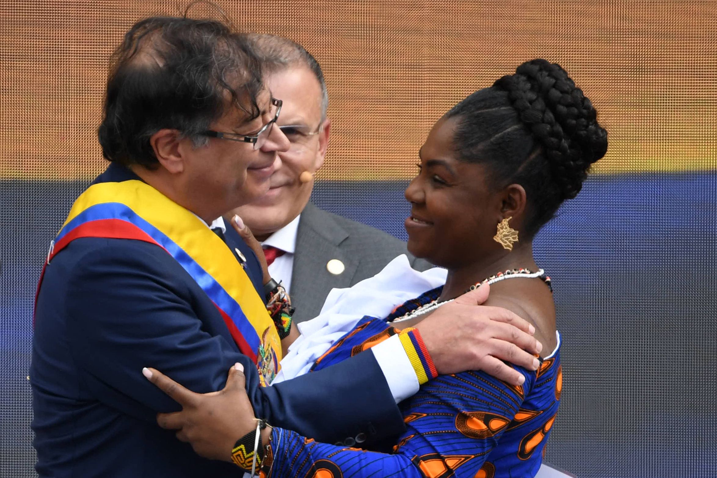 Colombia's new President Gustavo Petro (L) and Vice-president Francia Marquez greet during the inauguration ceremony at the Bolivar square in Bogota, on August 7, 2022. - Ex-guerrilla and former mayor Gustavo Petro was sworn in as Colombia's first-ever leftist president, with plans for profound reforms in a country beset by economic inequality and drug violence. (Photo by JUAN BARRETO / AFP)