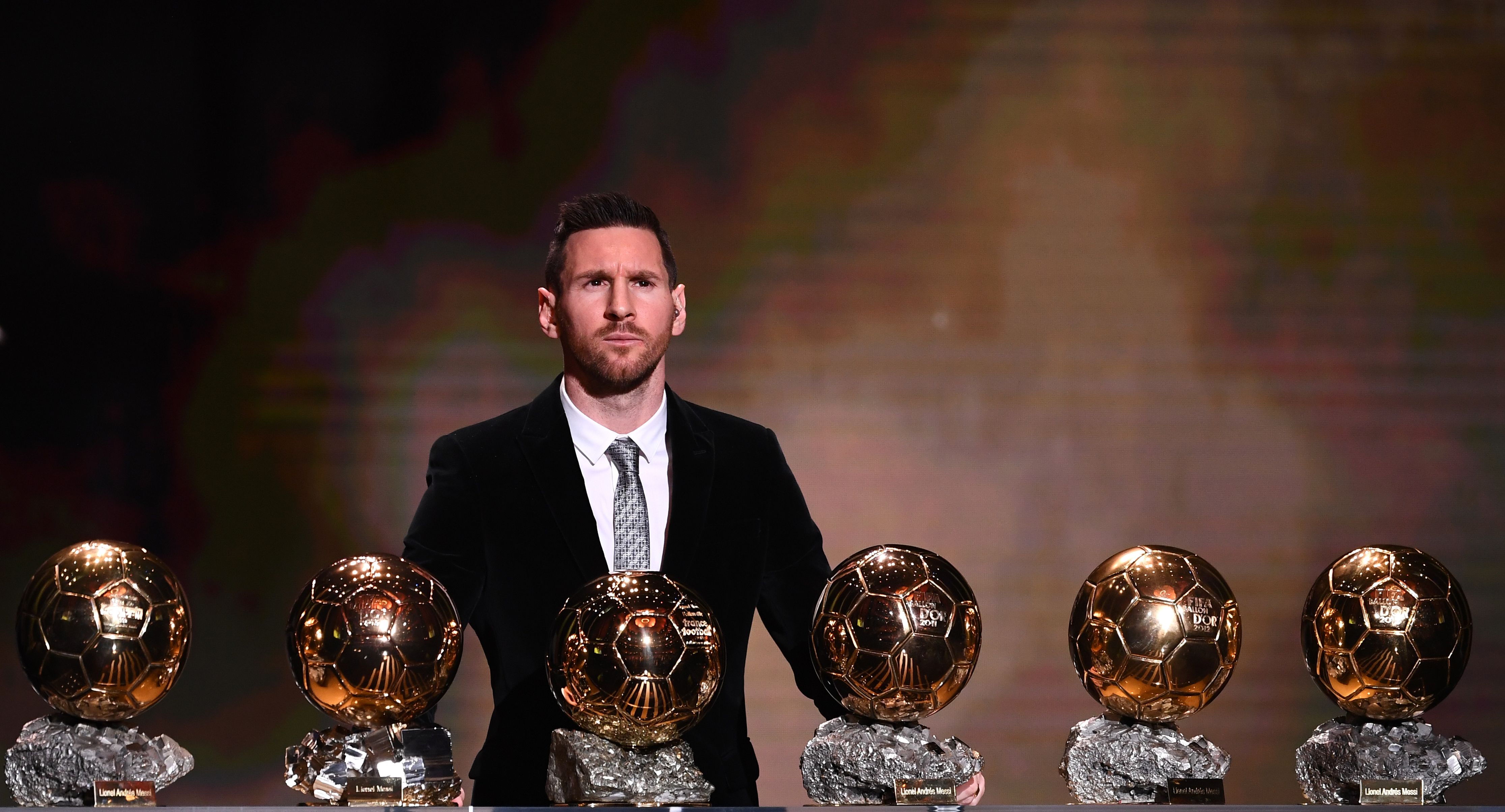 Barcelona's Argentinian forward Lionel Messi reacts after winning the Ballon d'Or France Football 2019 trophy at the Chatelet Theatre in Paris on December 2, 2019. - Lionel Messi won a record-breaking sixth Ballon d'Or on Monday after another sublime year for the Argentinian, whose familiar brilliance remained undimmed even through difficult times for club and country. (Photo by FRANCK FIFE / AFP)