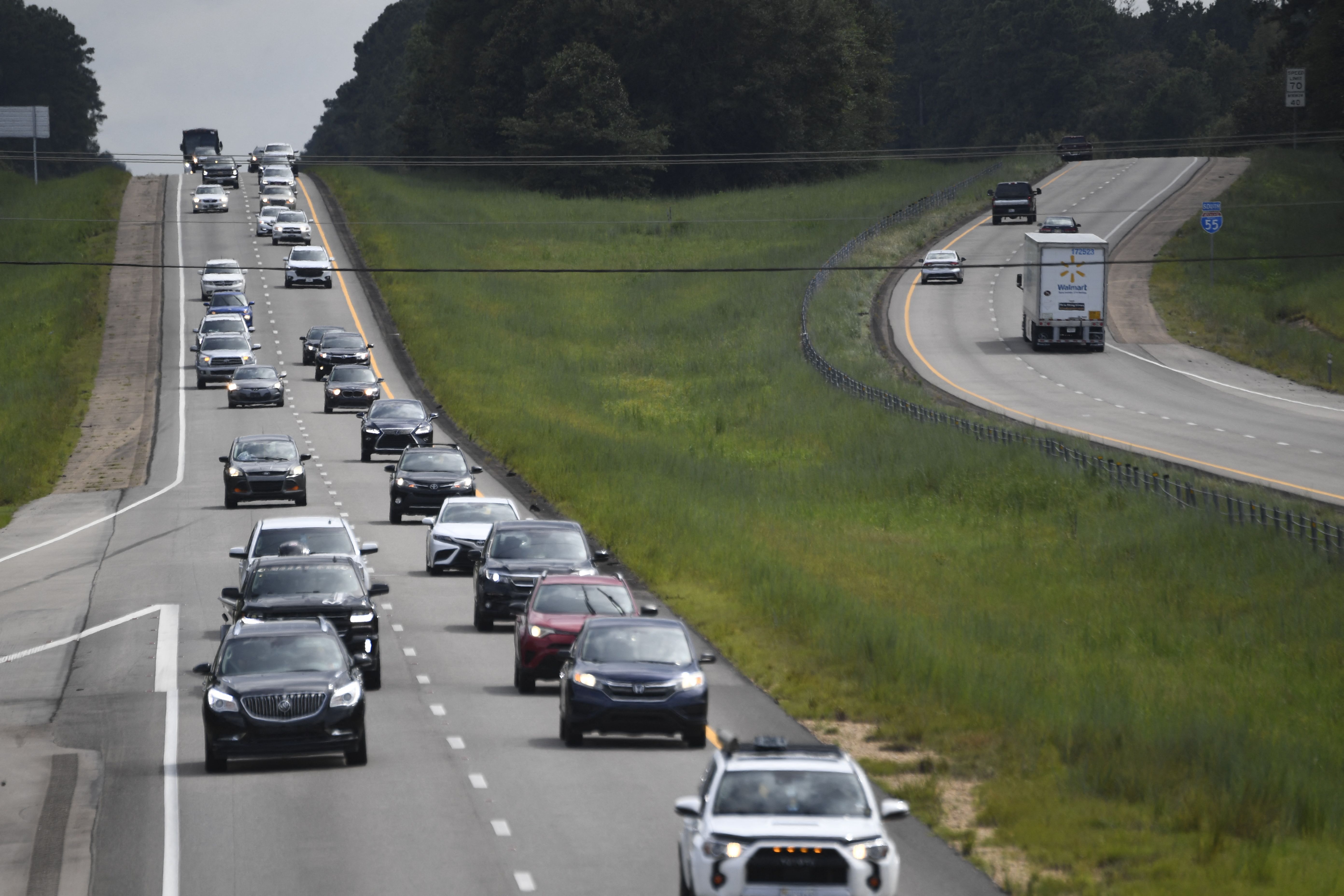 Residents drive north (L) on Interstate Highway 55 near Magnolia, Mississippi, as they evacuate away from New Orleans on August 28, 2021, before the arrival of Hurricane Ida. - Authorities in Louisiana and elsewhere on the US Gulf Coast issued increasingly dire sounding warnings Saturday as Hurricane Ida, a storm expected to pack powerful 130mph (209kph) winds, moved with unexpected speed toward the New Orleans area. (Photo by Patrick T. FALLON / AFP)